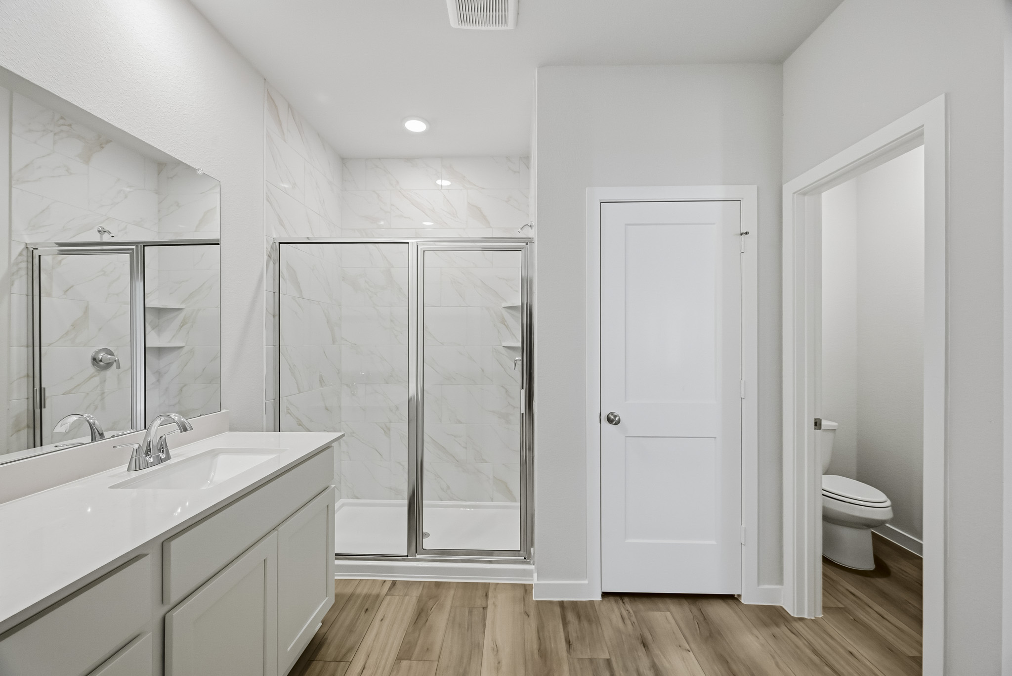 A bathroom with a glass shower.