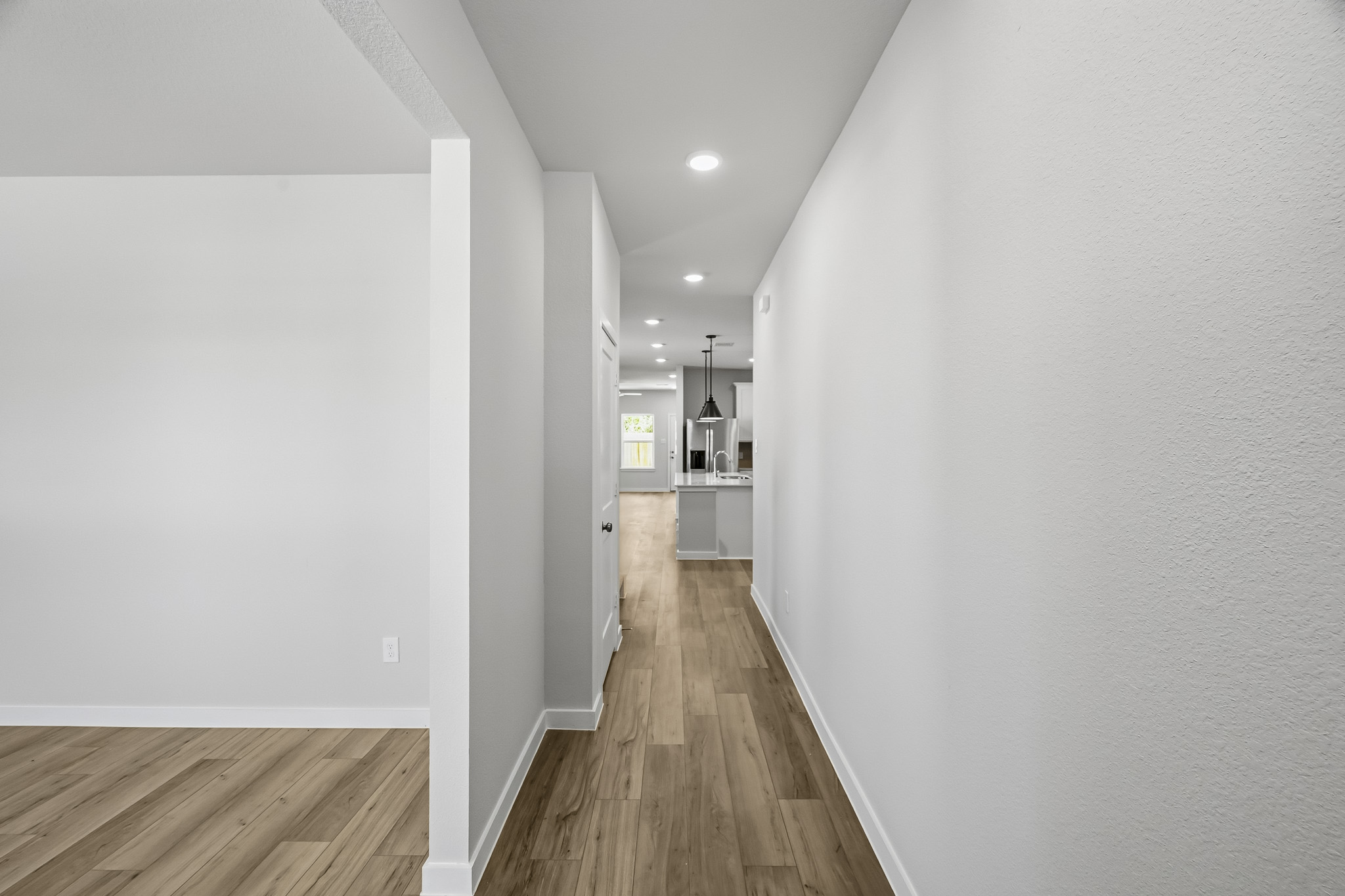 A hallway with white walls.