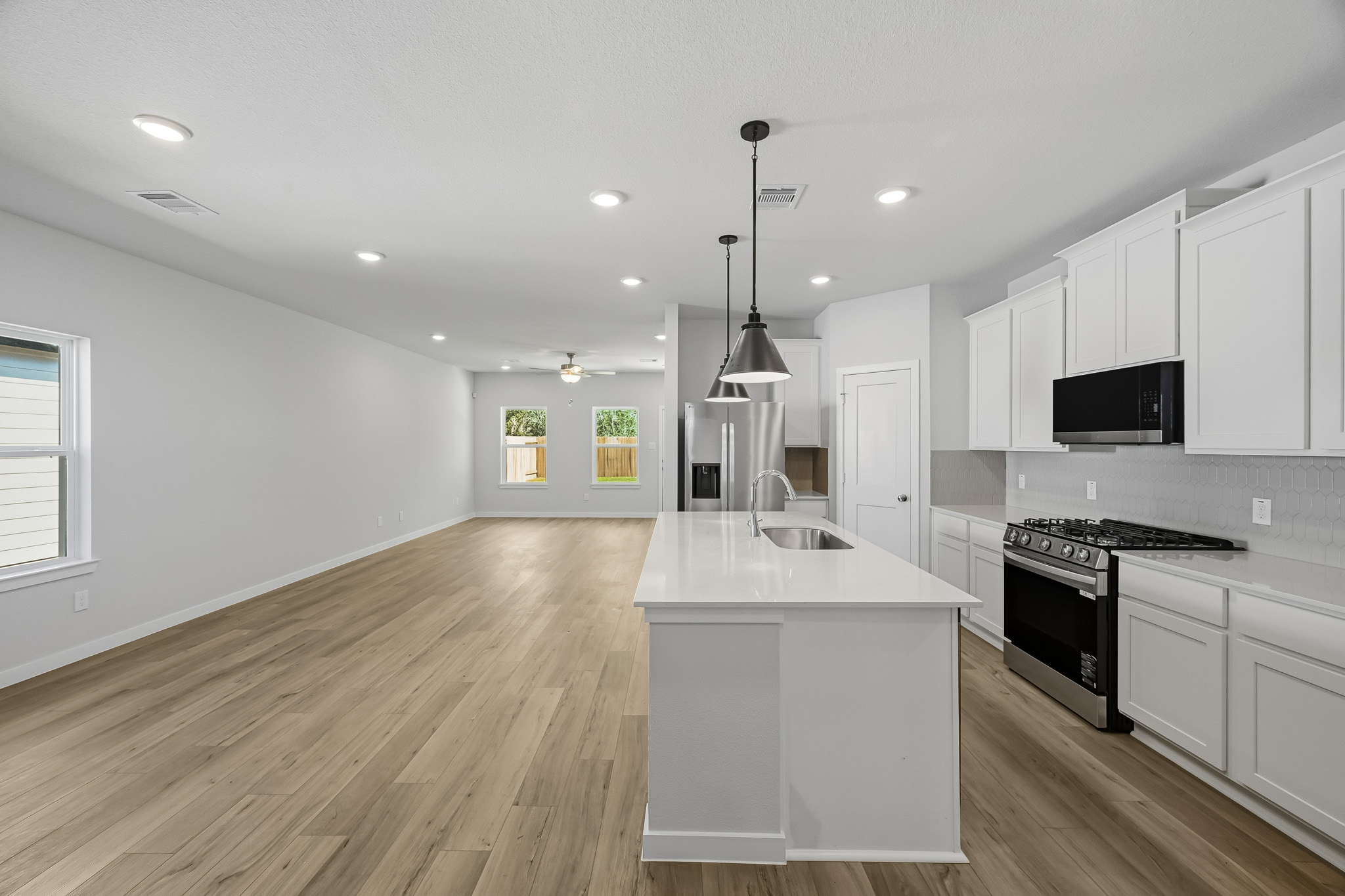 A kitchen with white cabinets.