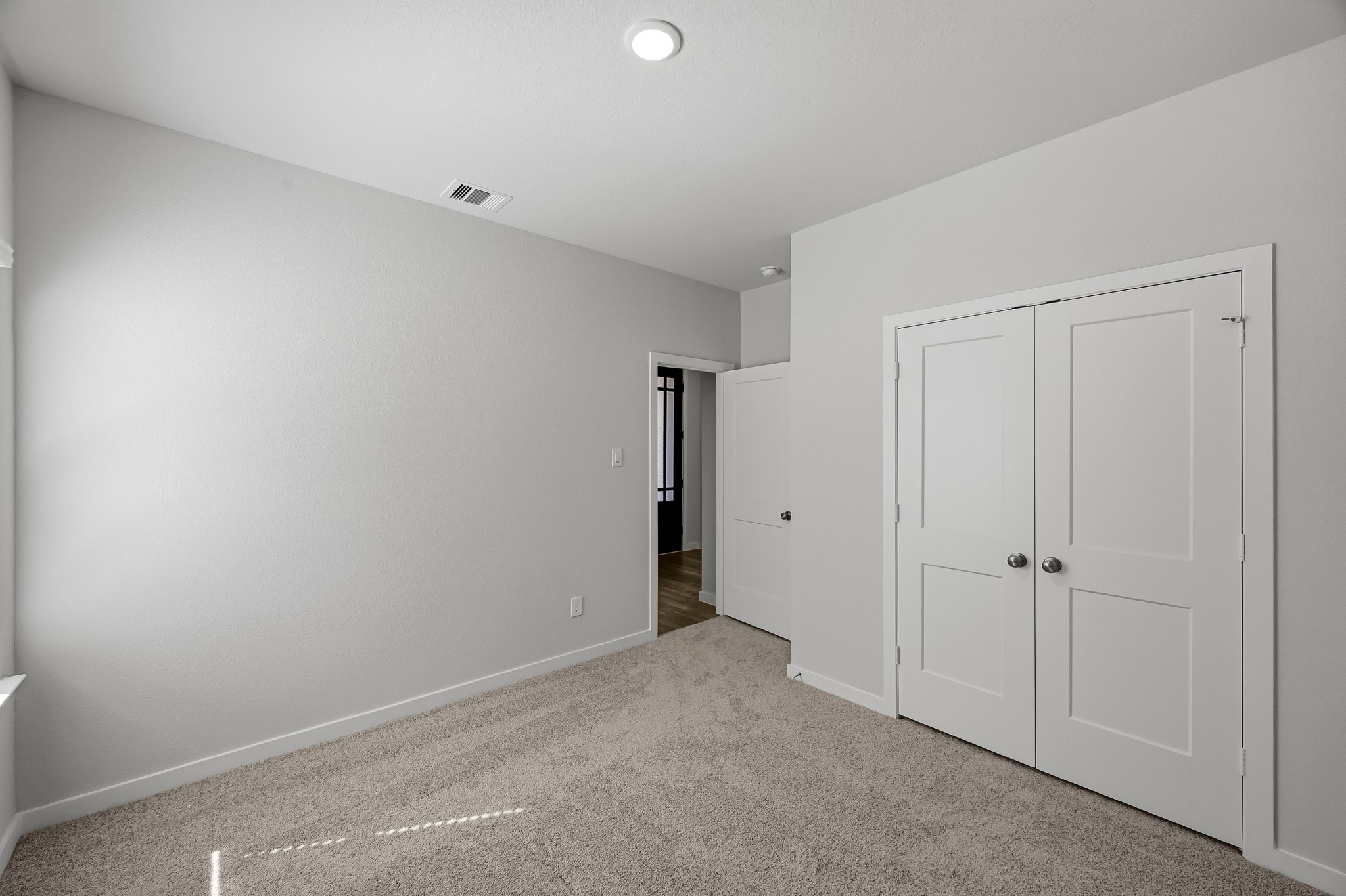 A hallway with white doors.