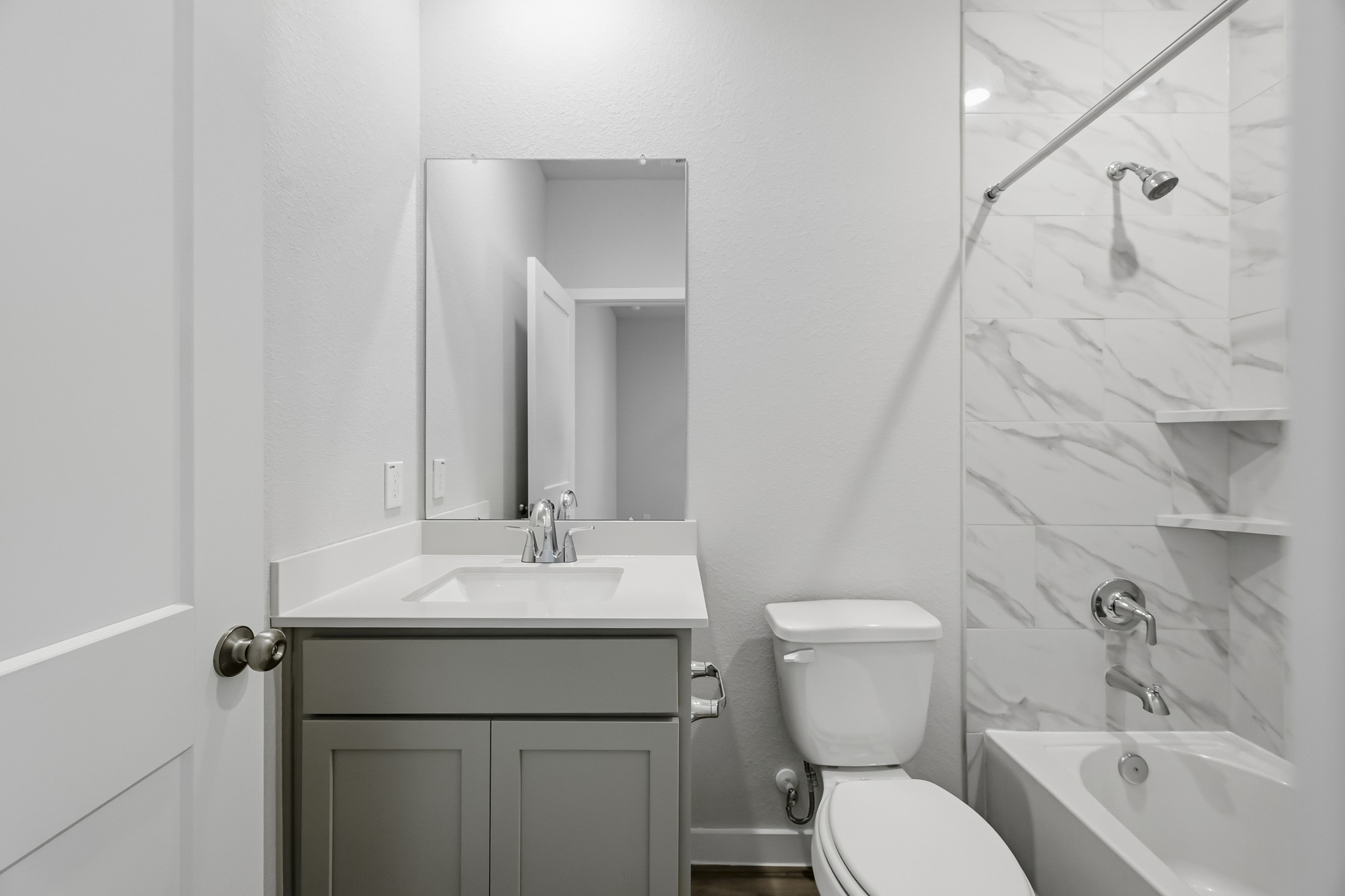 A bathroom with a glass shower.
