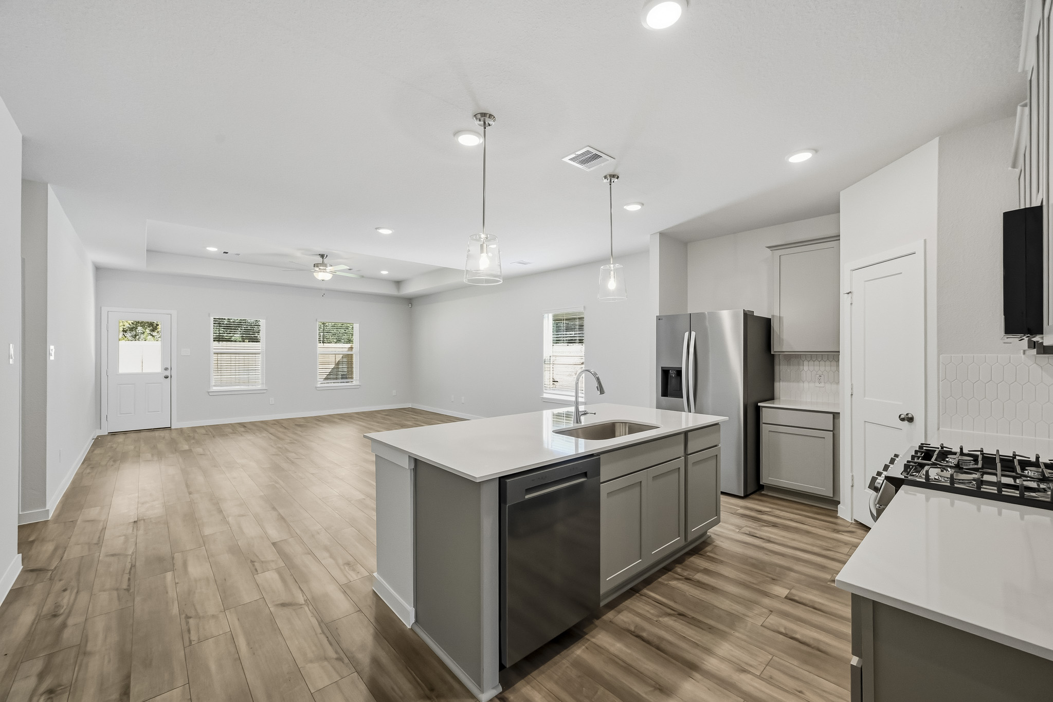 A kitchen with a wood floor.