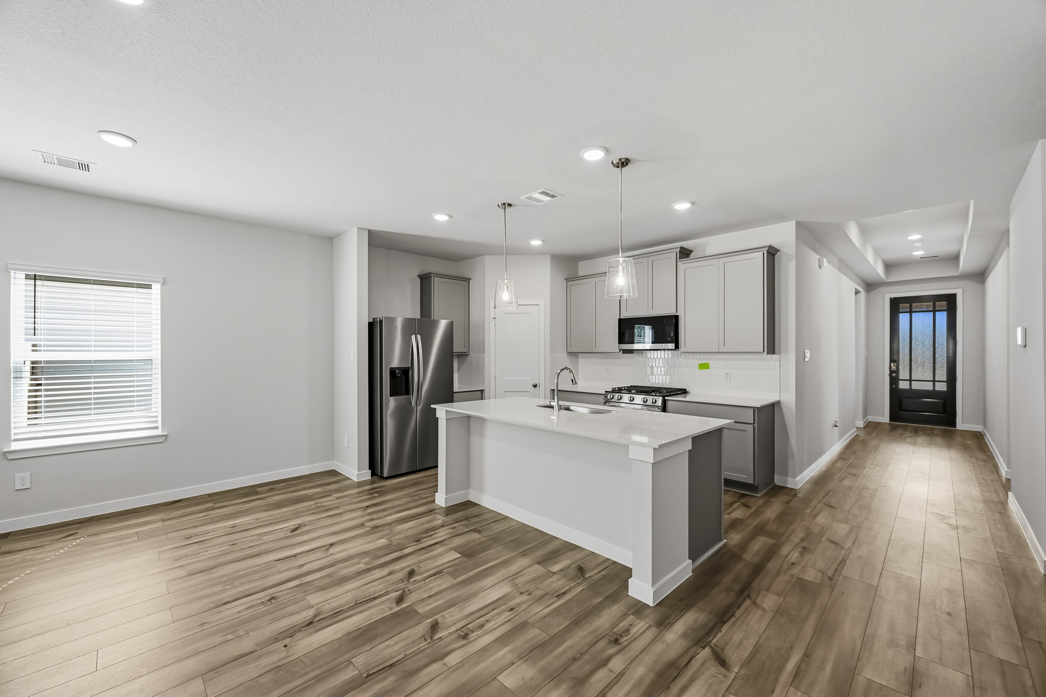 A kitchen with a wood floor.