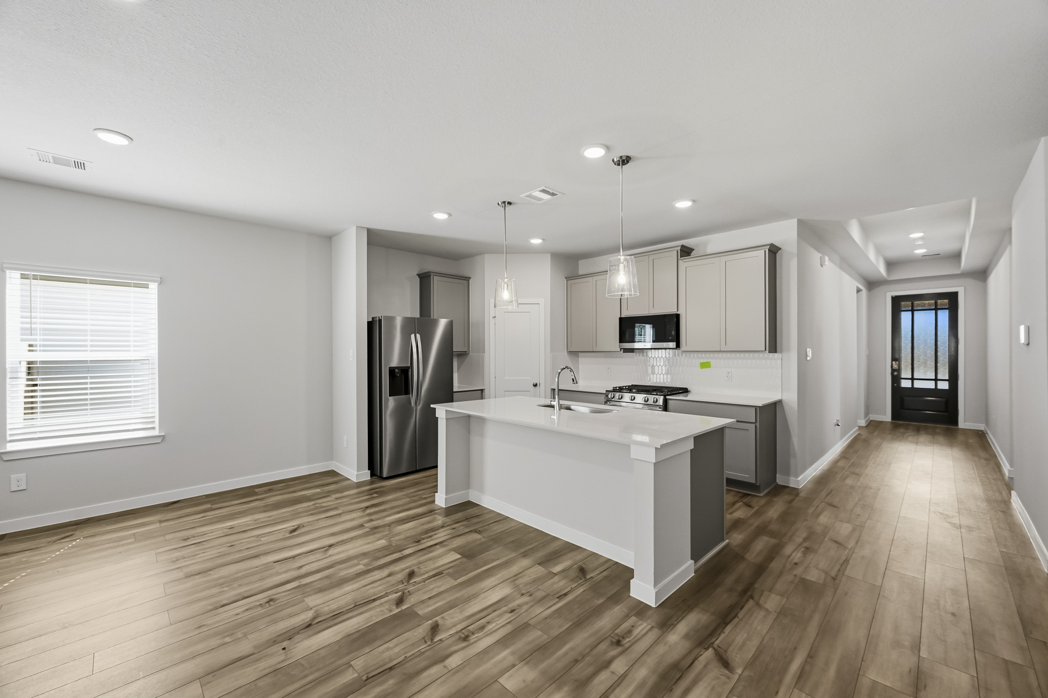 A kitchen with a wood floor.