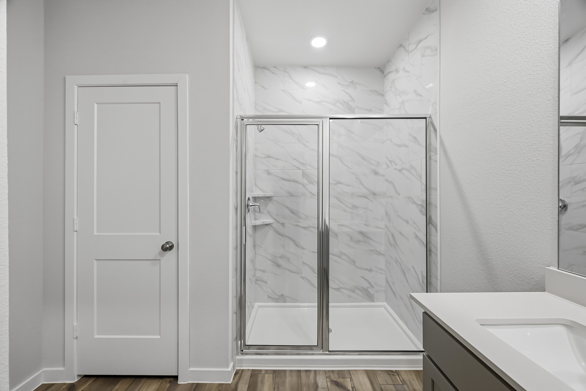 A bathroom with a glass shower.