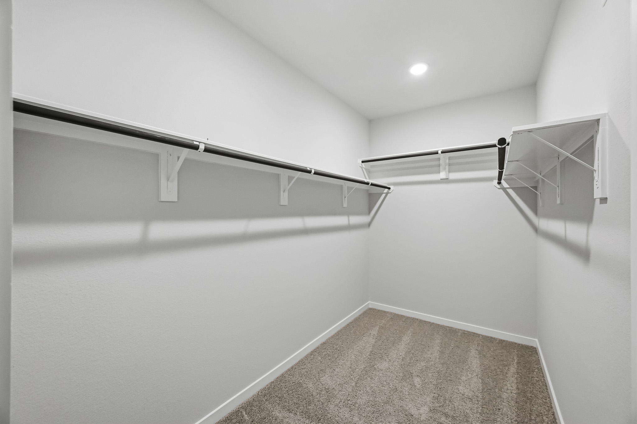 A hallway with a metal railing.