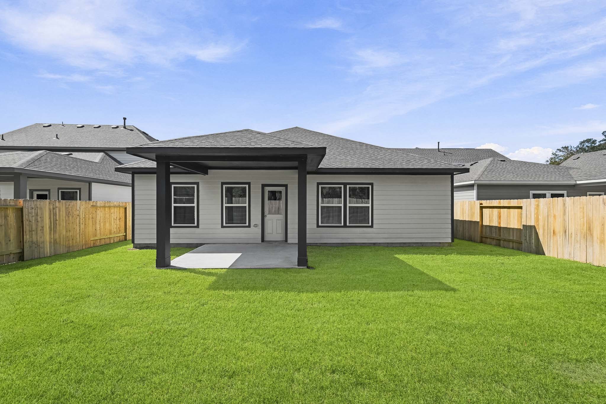 A house with a fence and grass.