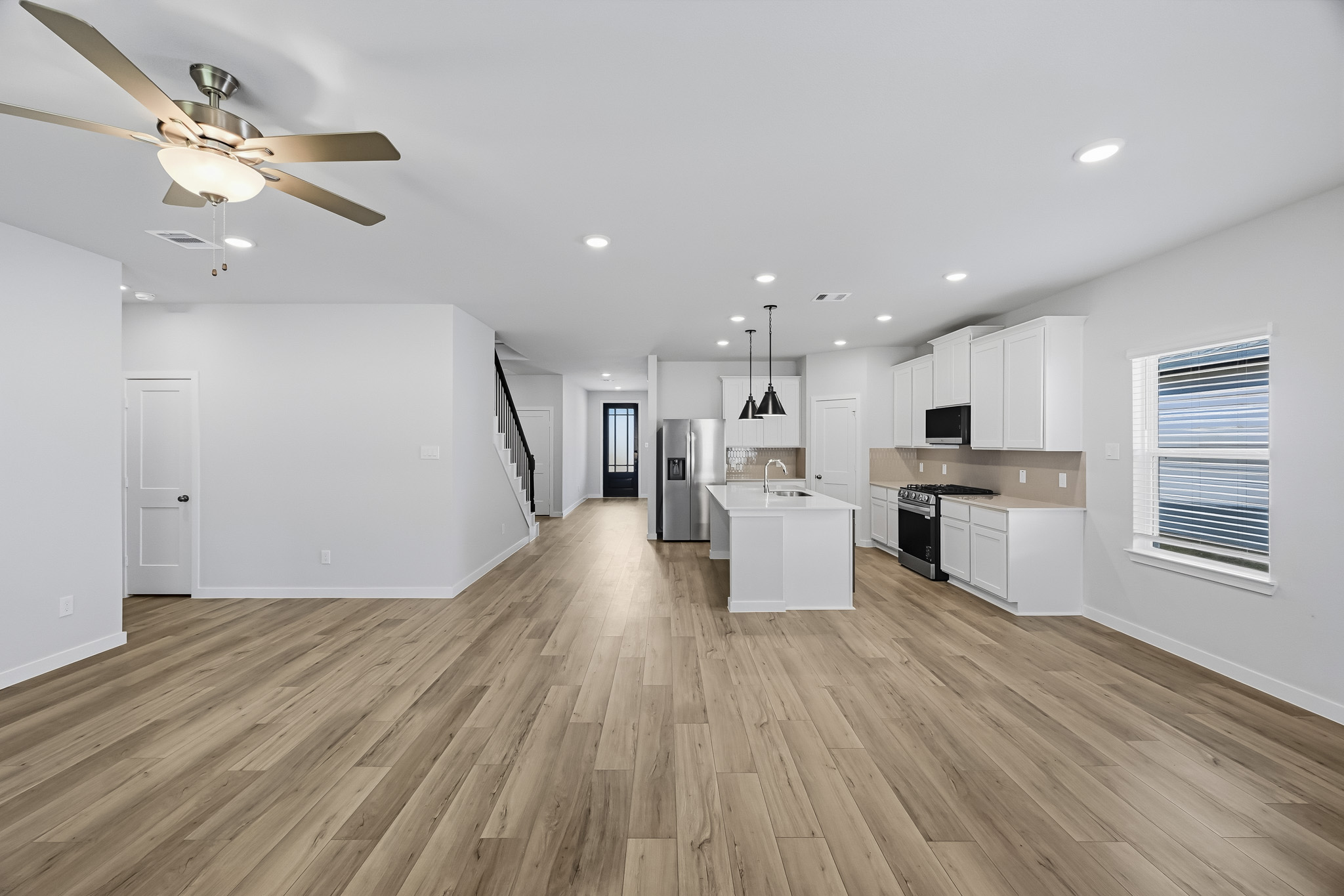 A large kitchen with white cabinets.