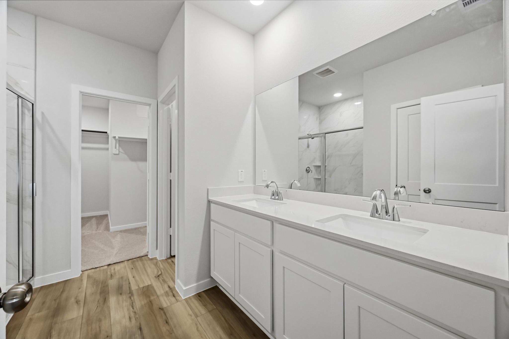 A bathroom with white cabinets.