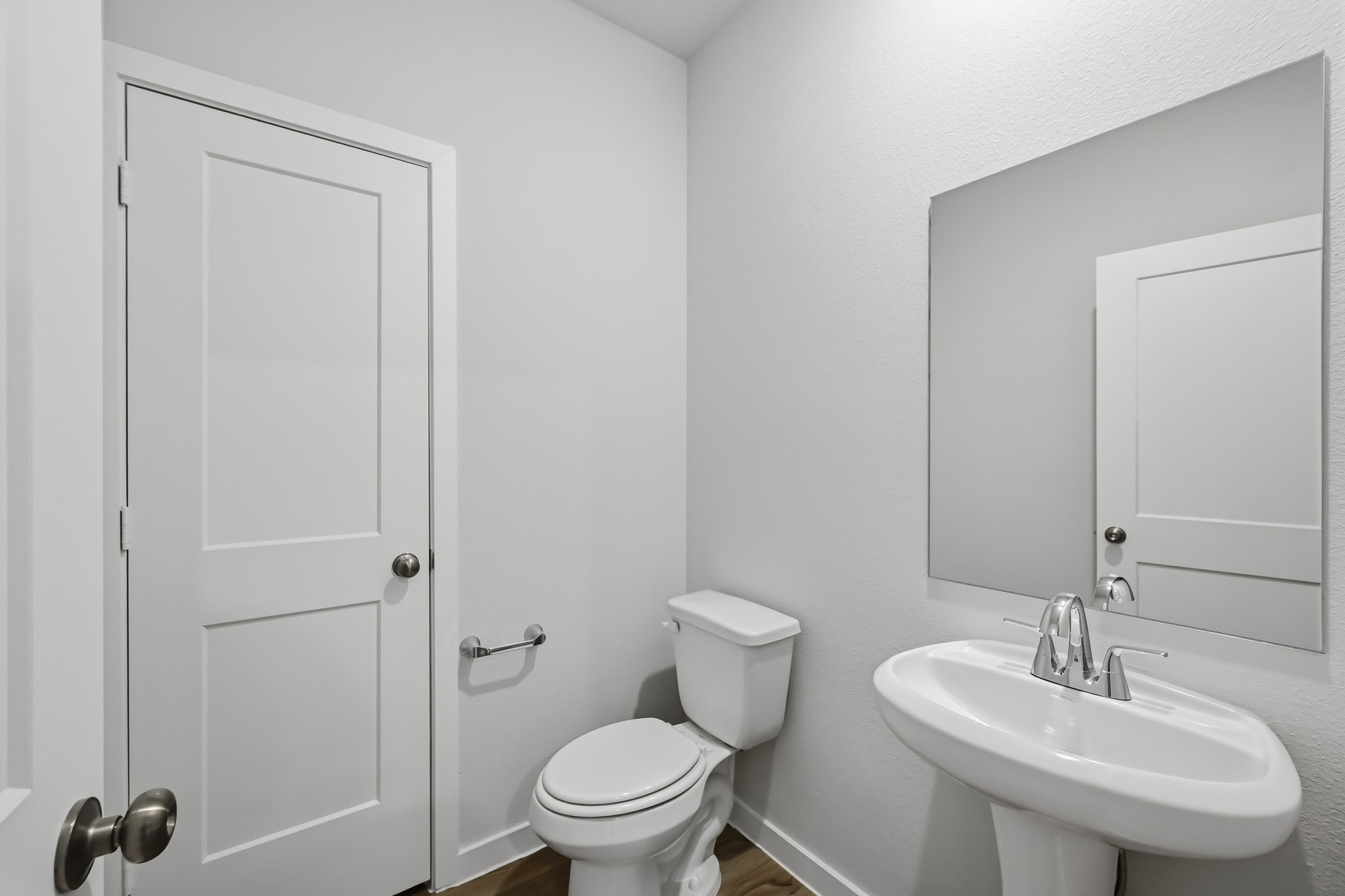 A bathroom with a toilet and sink.