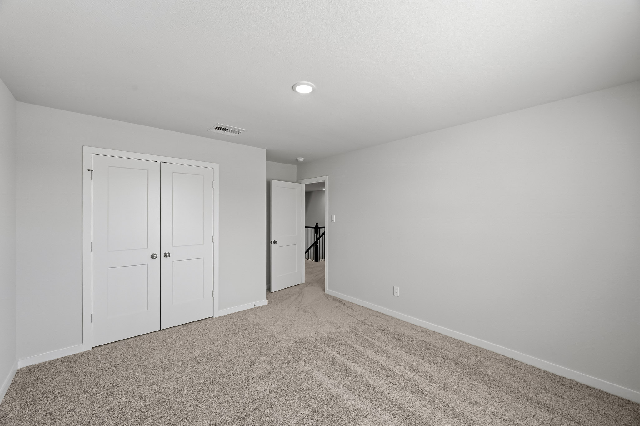 A hallway with white doors.