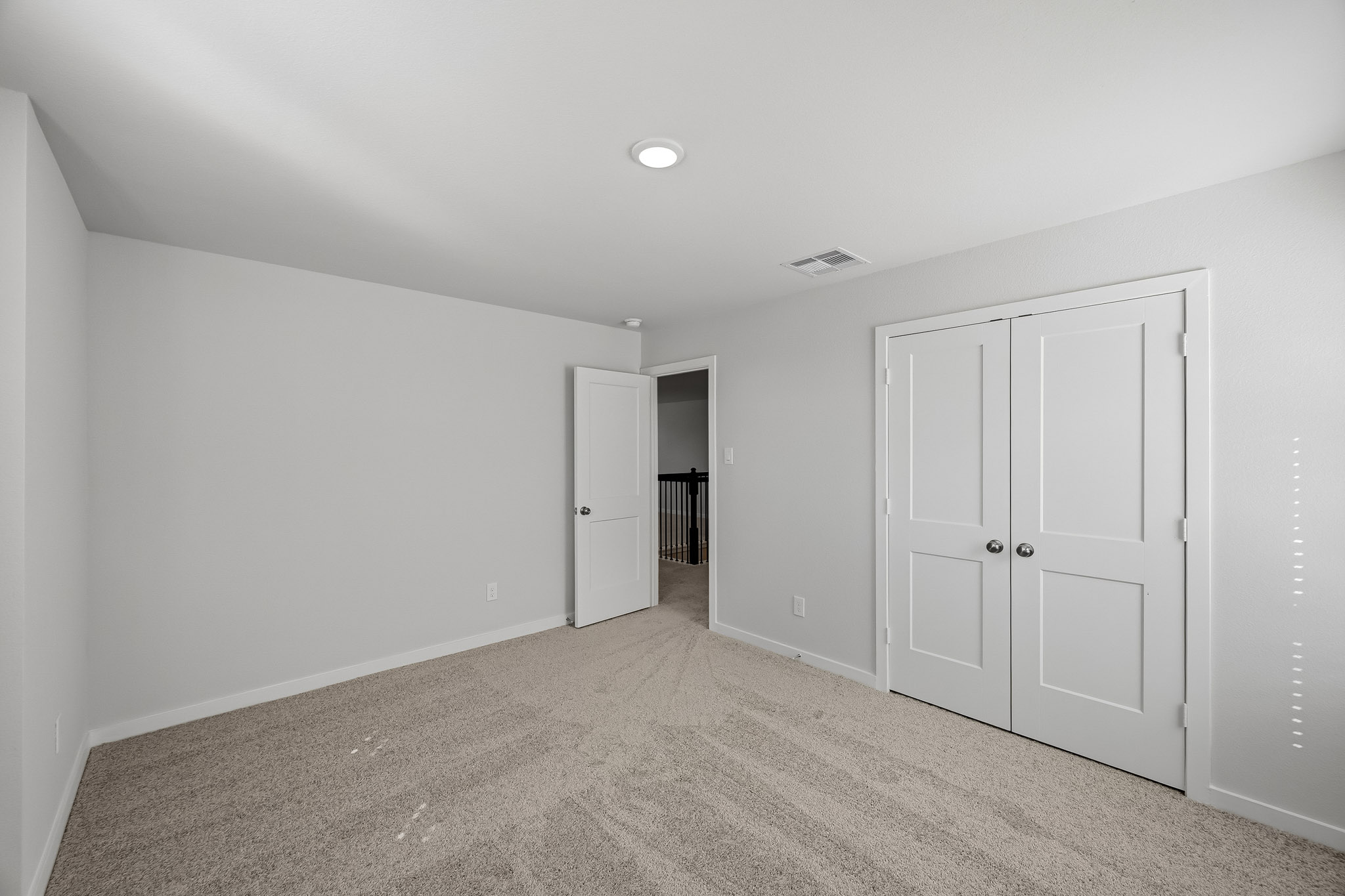 A hallway with white doors.