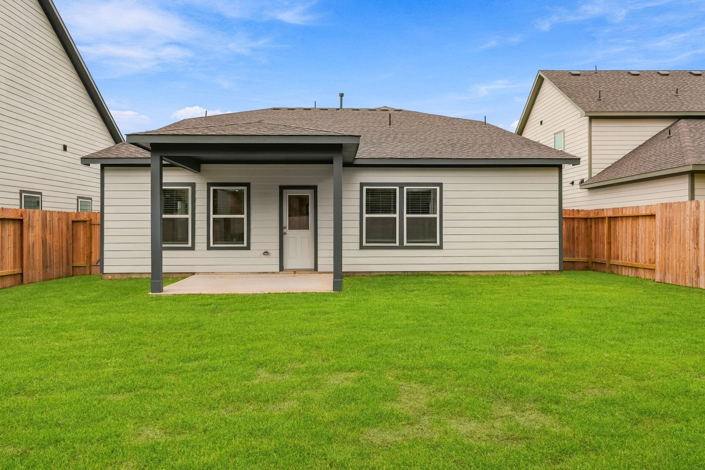 A house with a fence and grass.