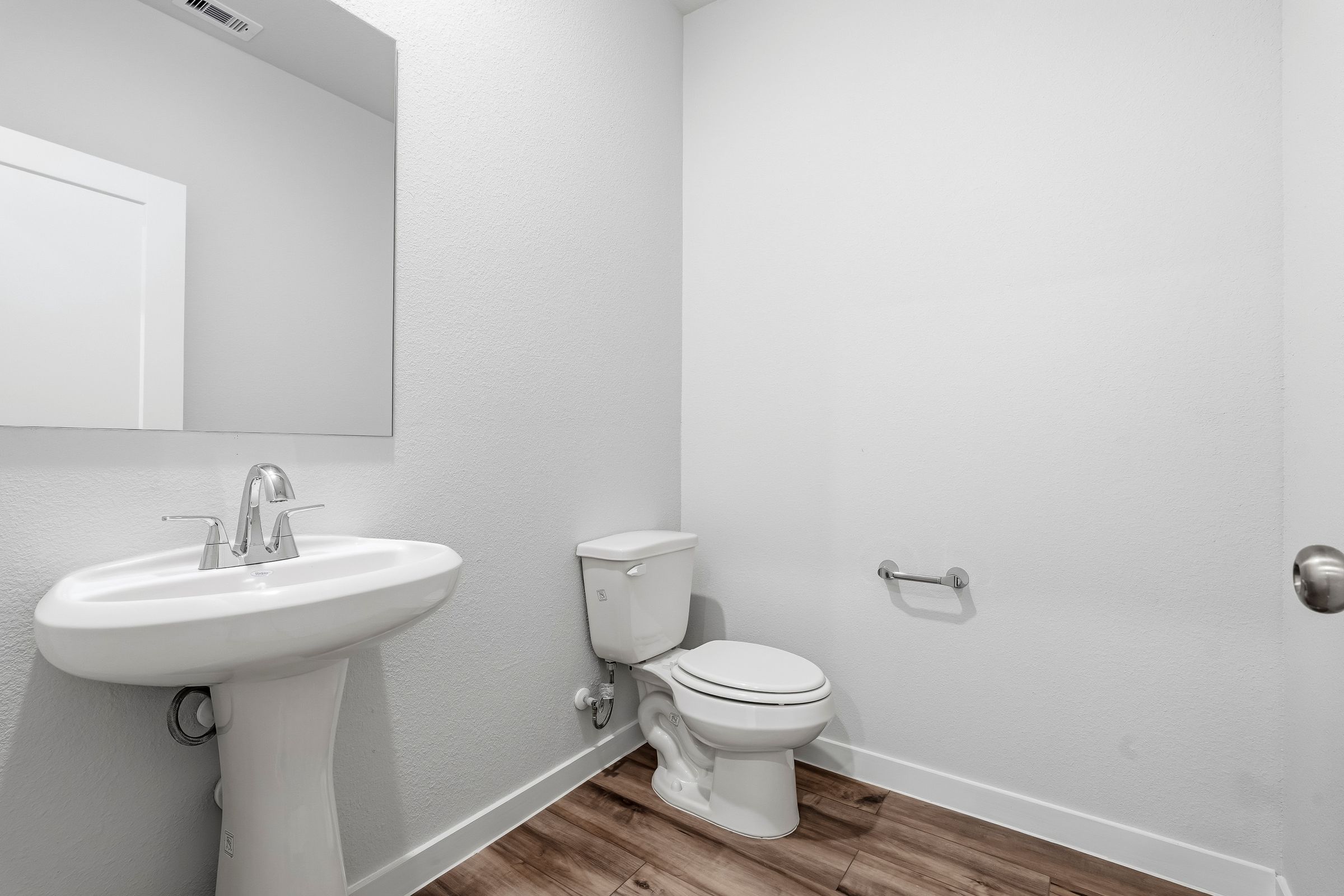 A bathroom with a toilet and sink.