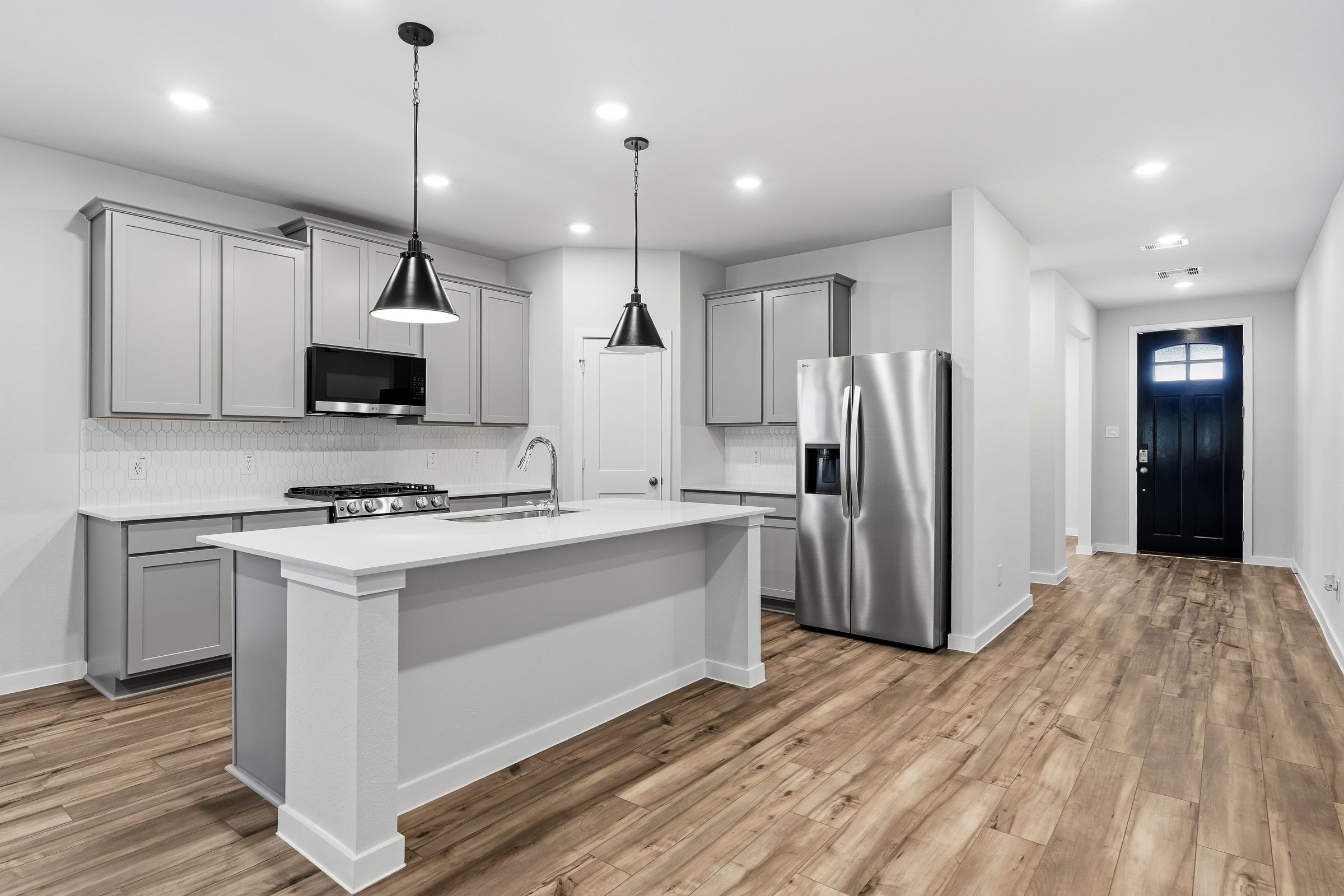 A kitchen with white cabinets.