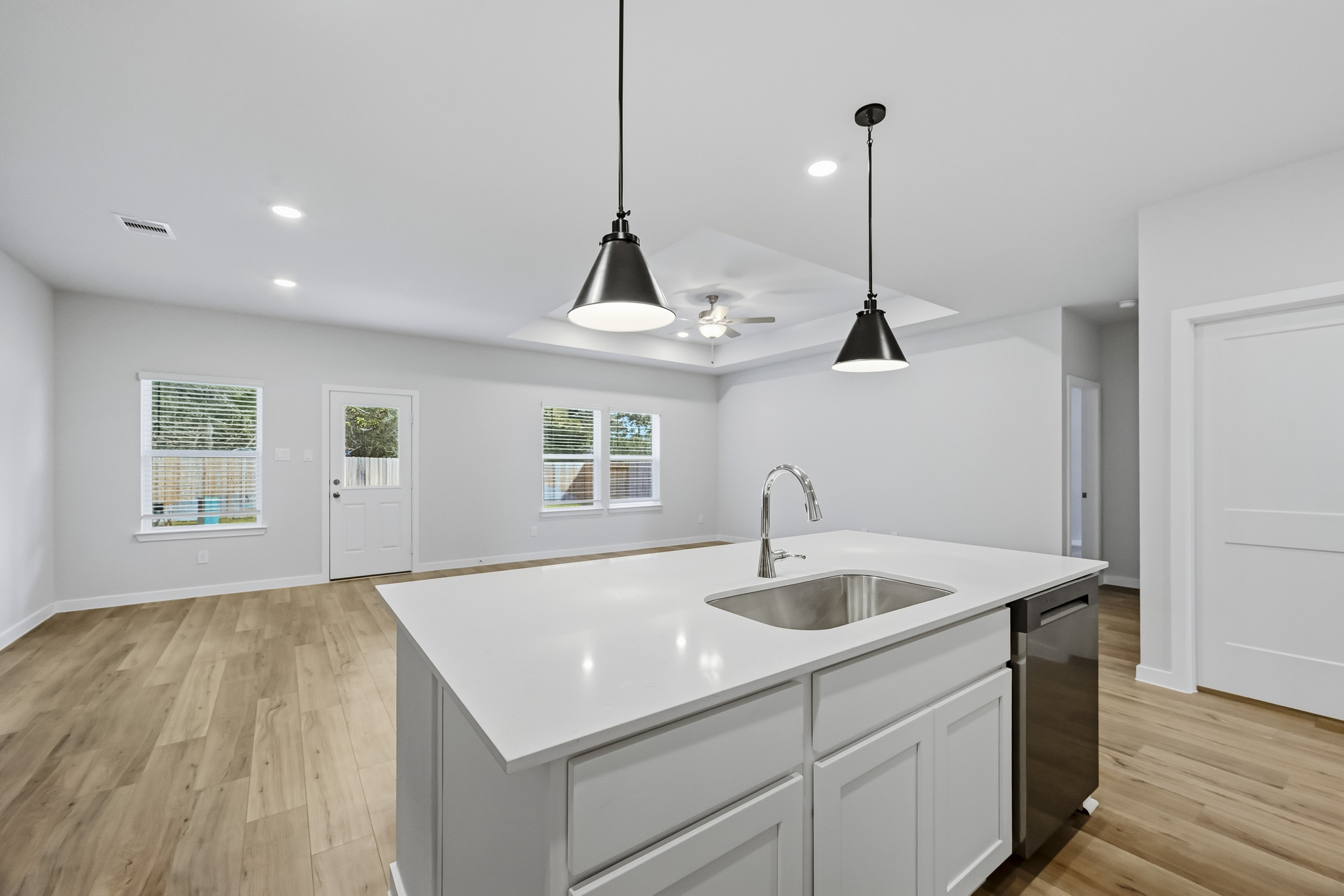 A kitchen with white cabinets.