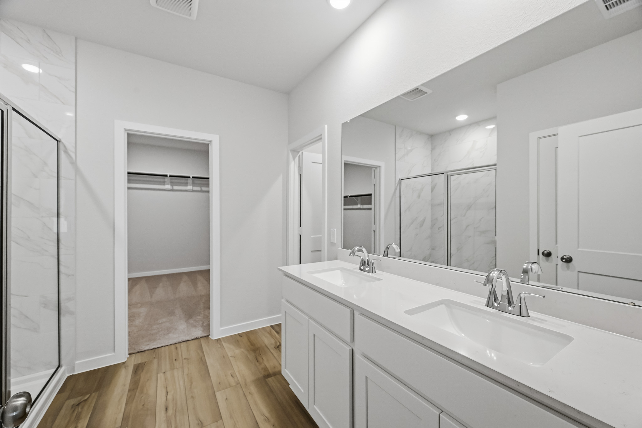 A bathroom with a large mirror.