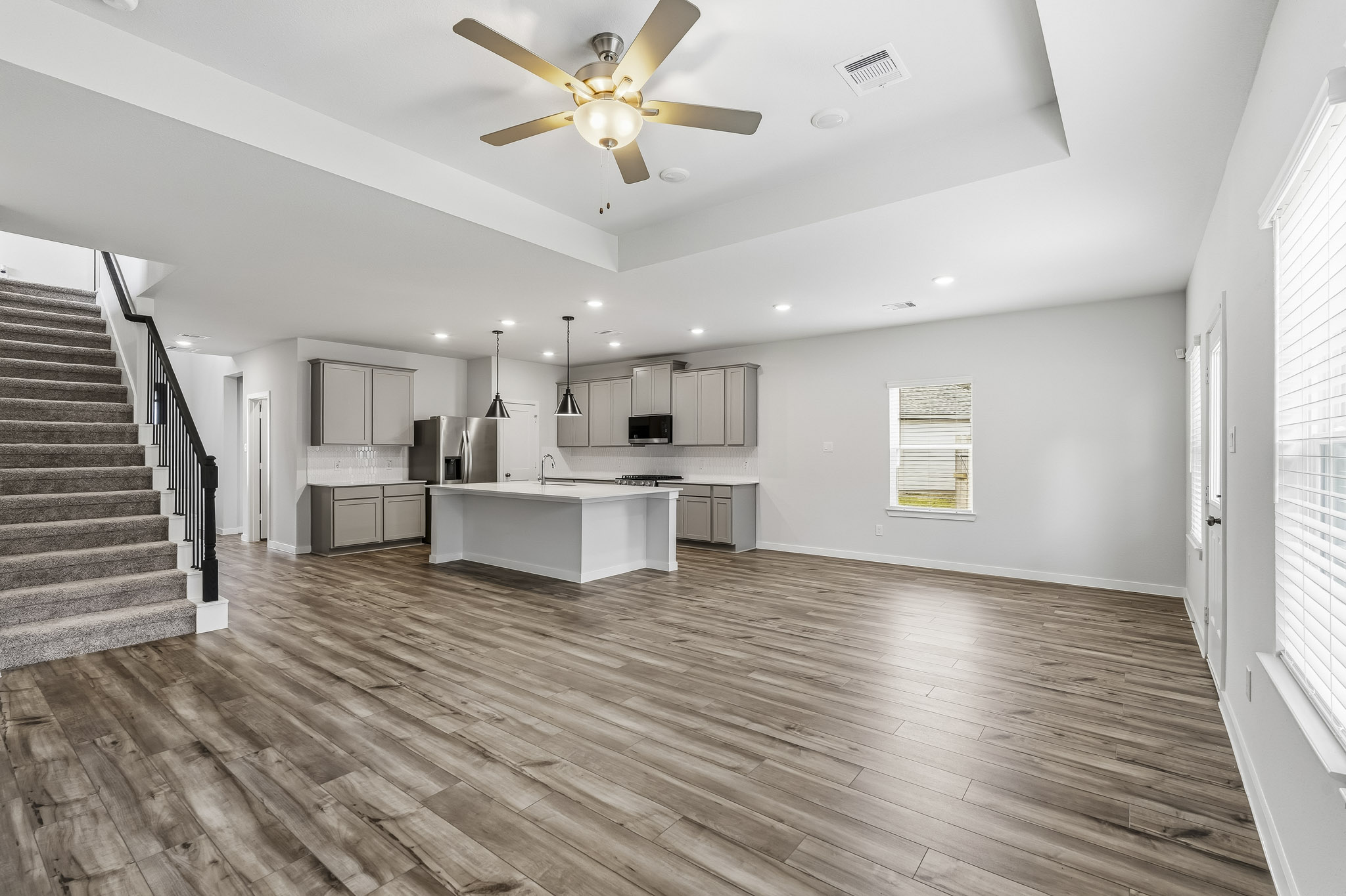 A large kitchen with a wood floor.