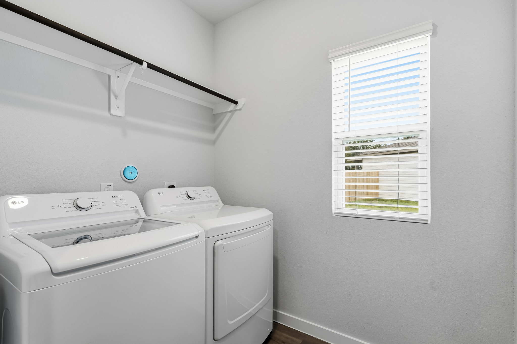 A washing machine and dryer in a room.