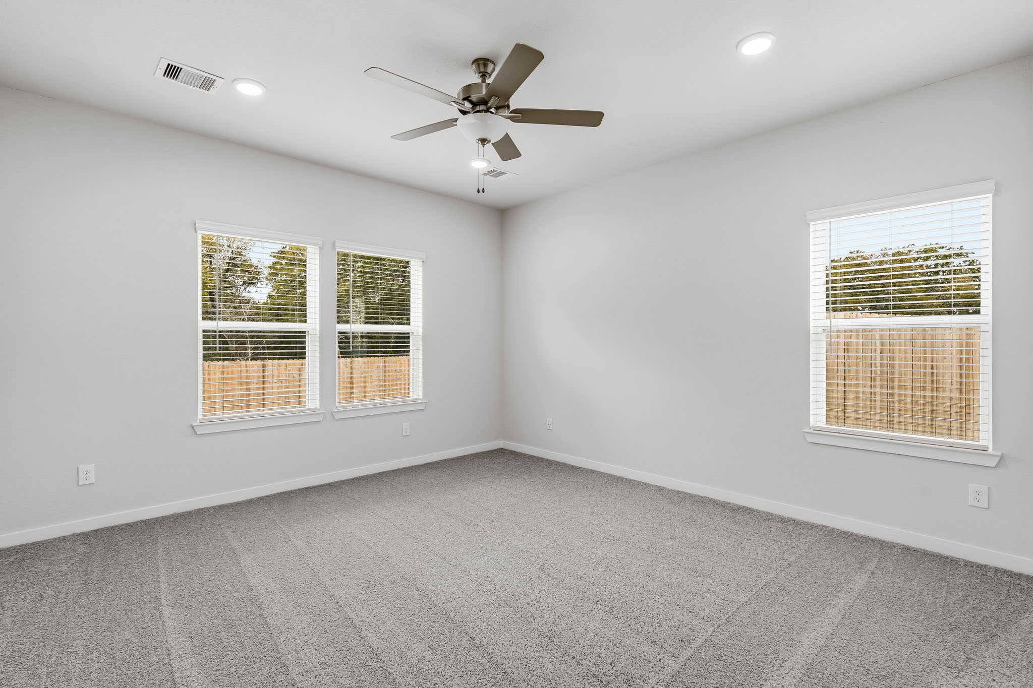 A room with a ceiling fan and a ceiling fan.