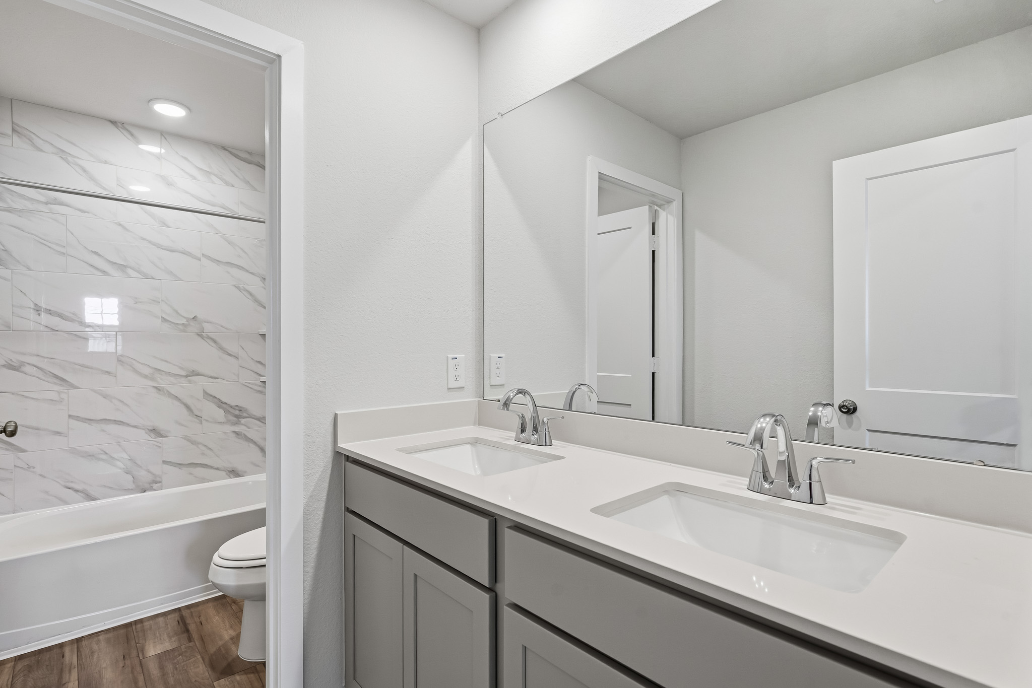 A bathroom with a tub sink and toilet.