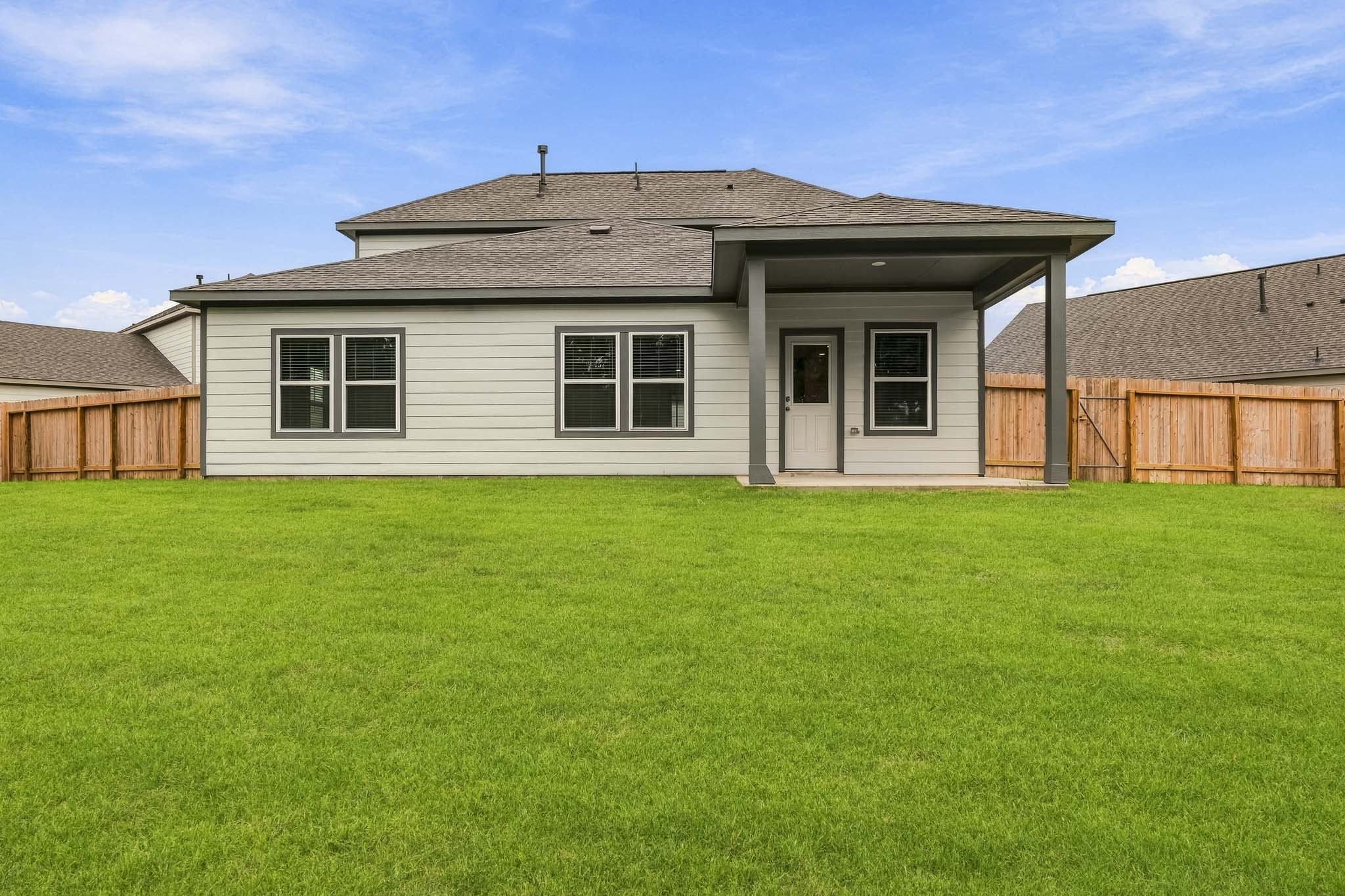 A house with a green lawn.