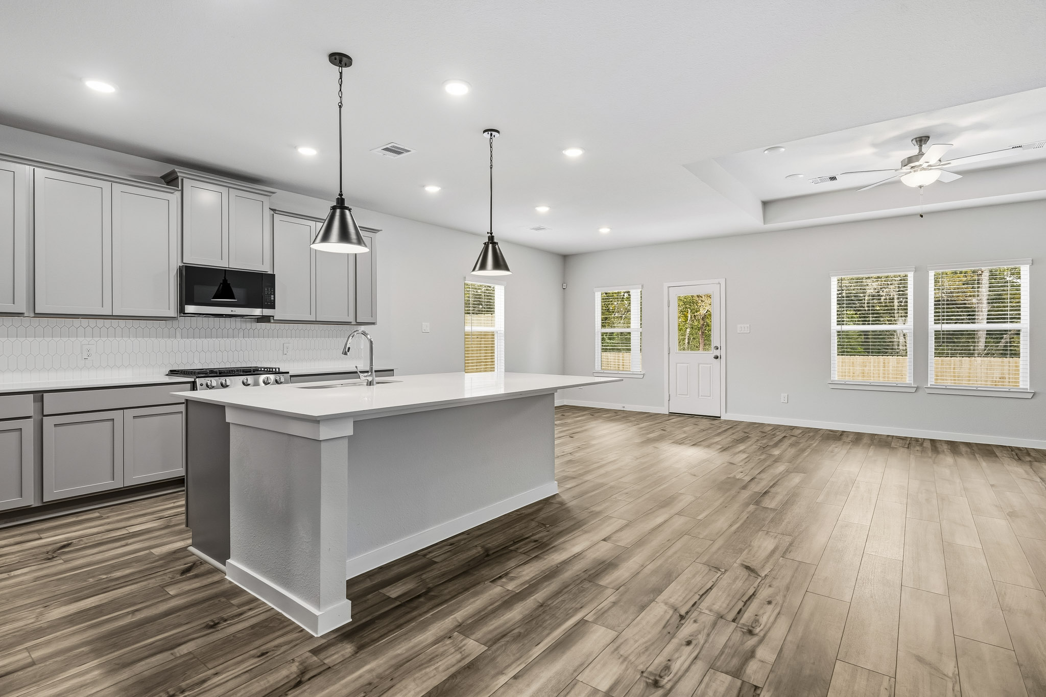 A kitchen with a wood floor.