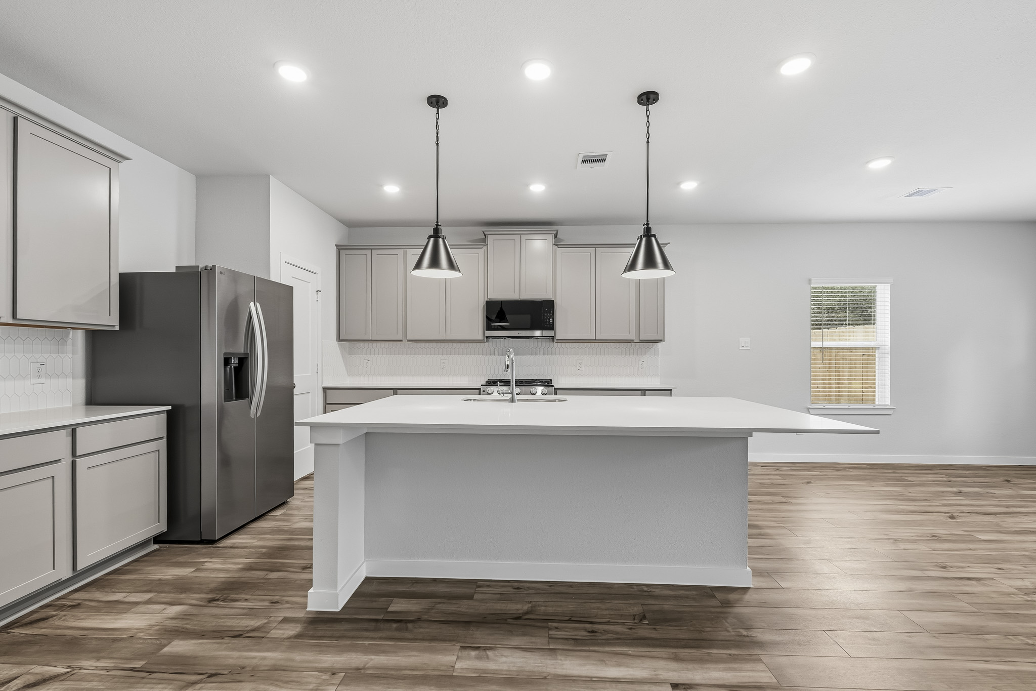 A kitchen with white cabinets.