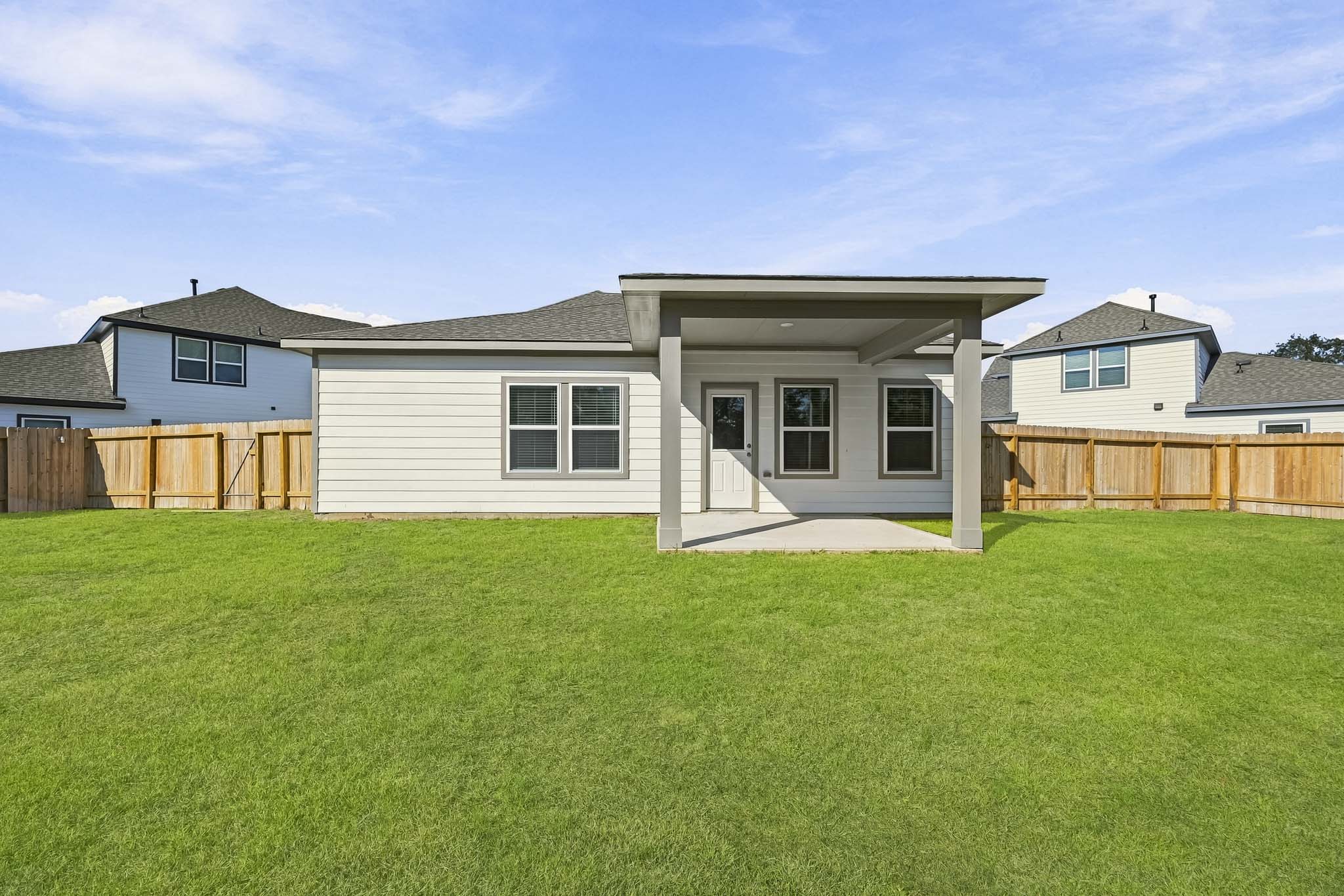 A house with a fence and grass.