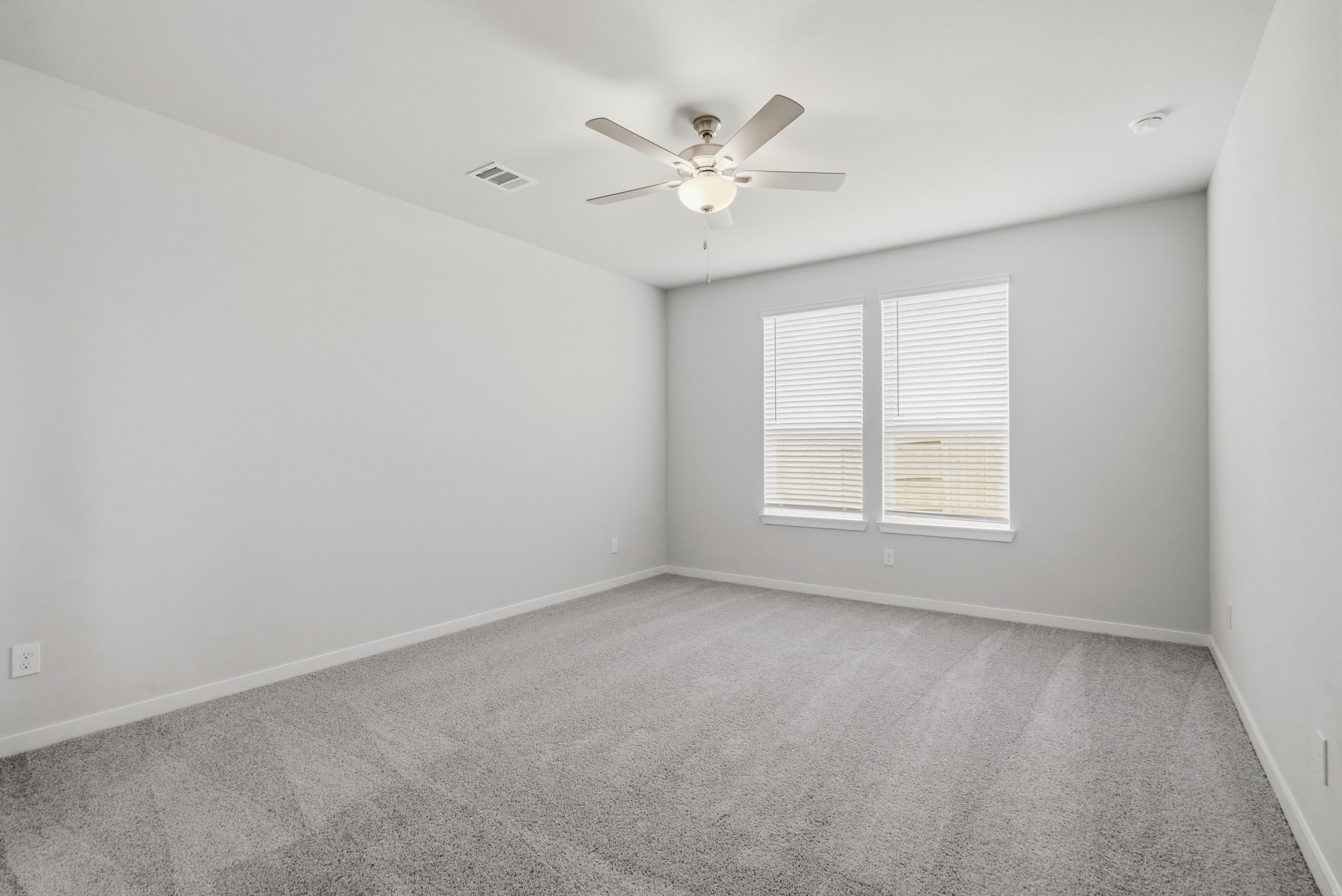 A room with a ceiling fan and a ceiling fan.