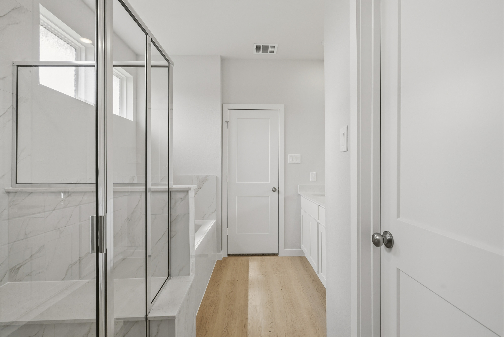 A bathroom with a glass shower.