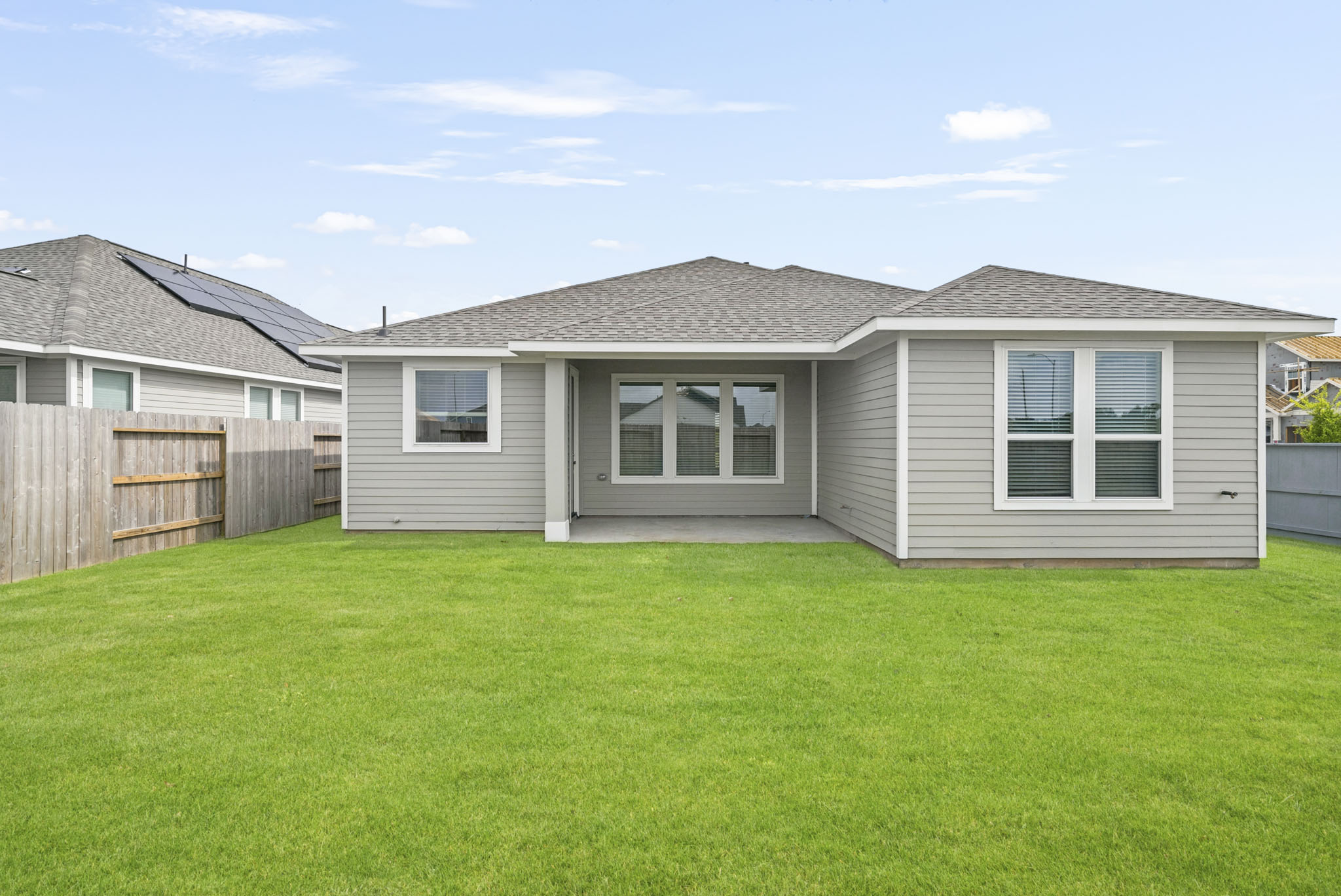 A house with a fence and grass.