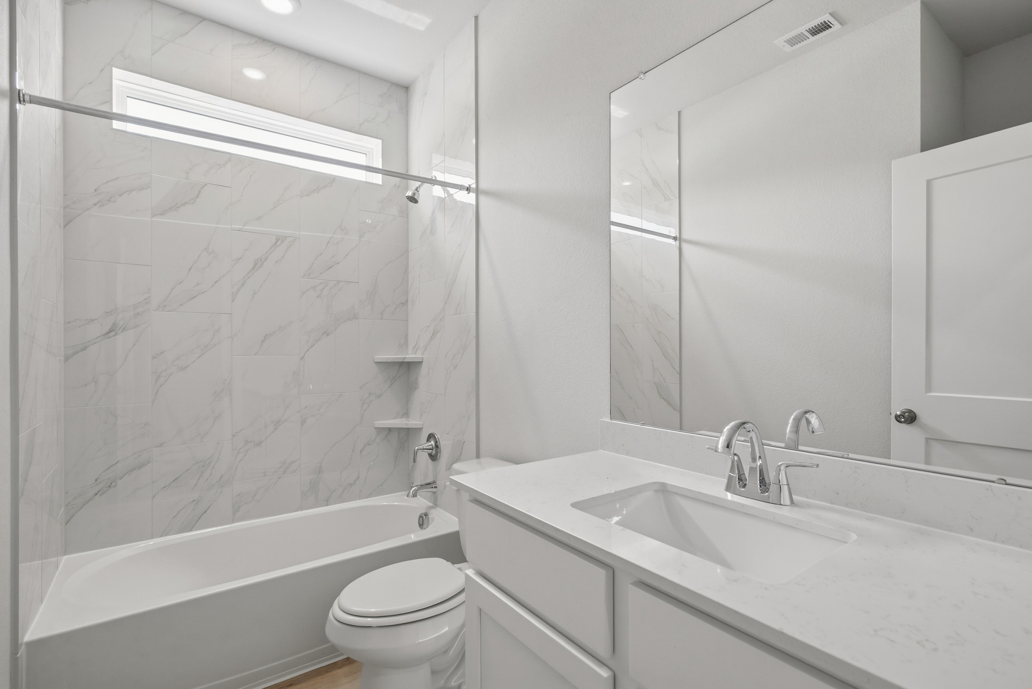 A bathroom with a shower and sink.
