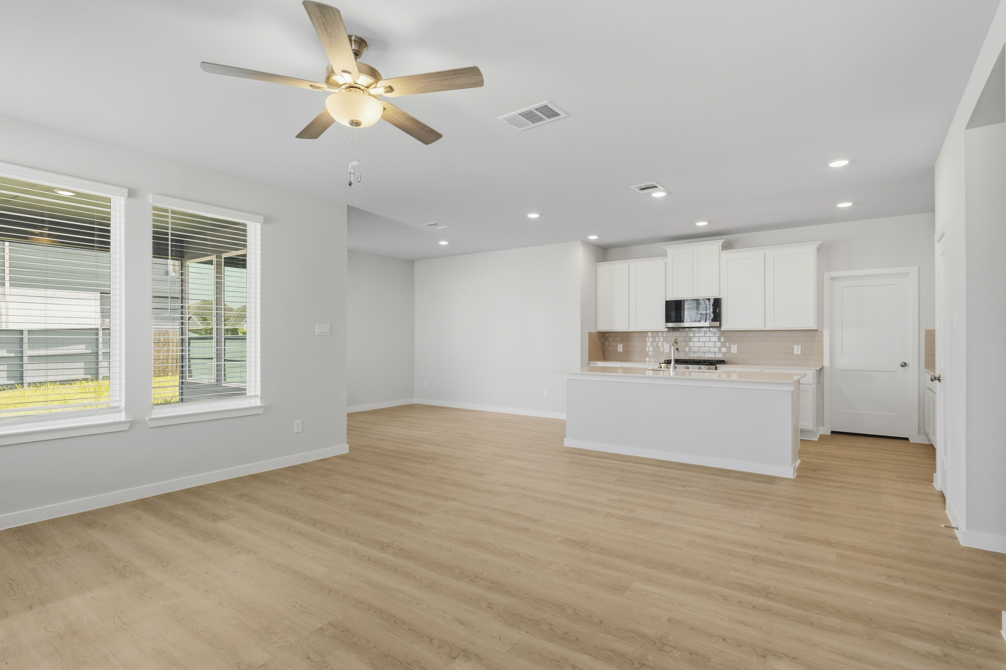 A large kitchen with white cabinets.