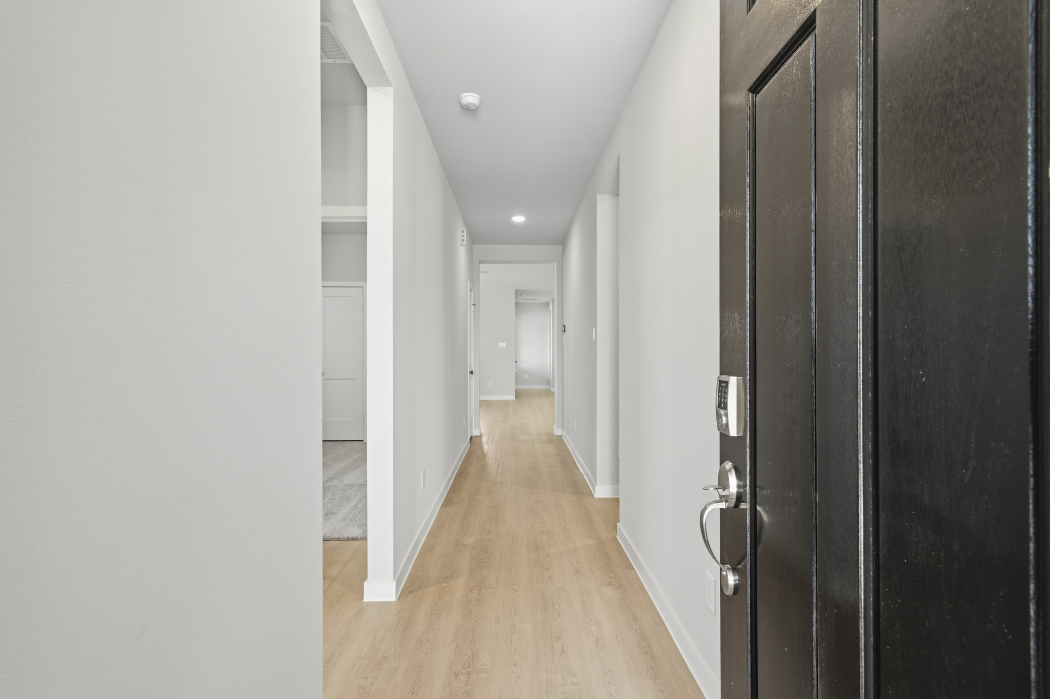 A hallway with black doors.