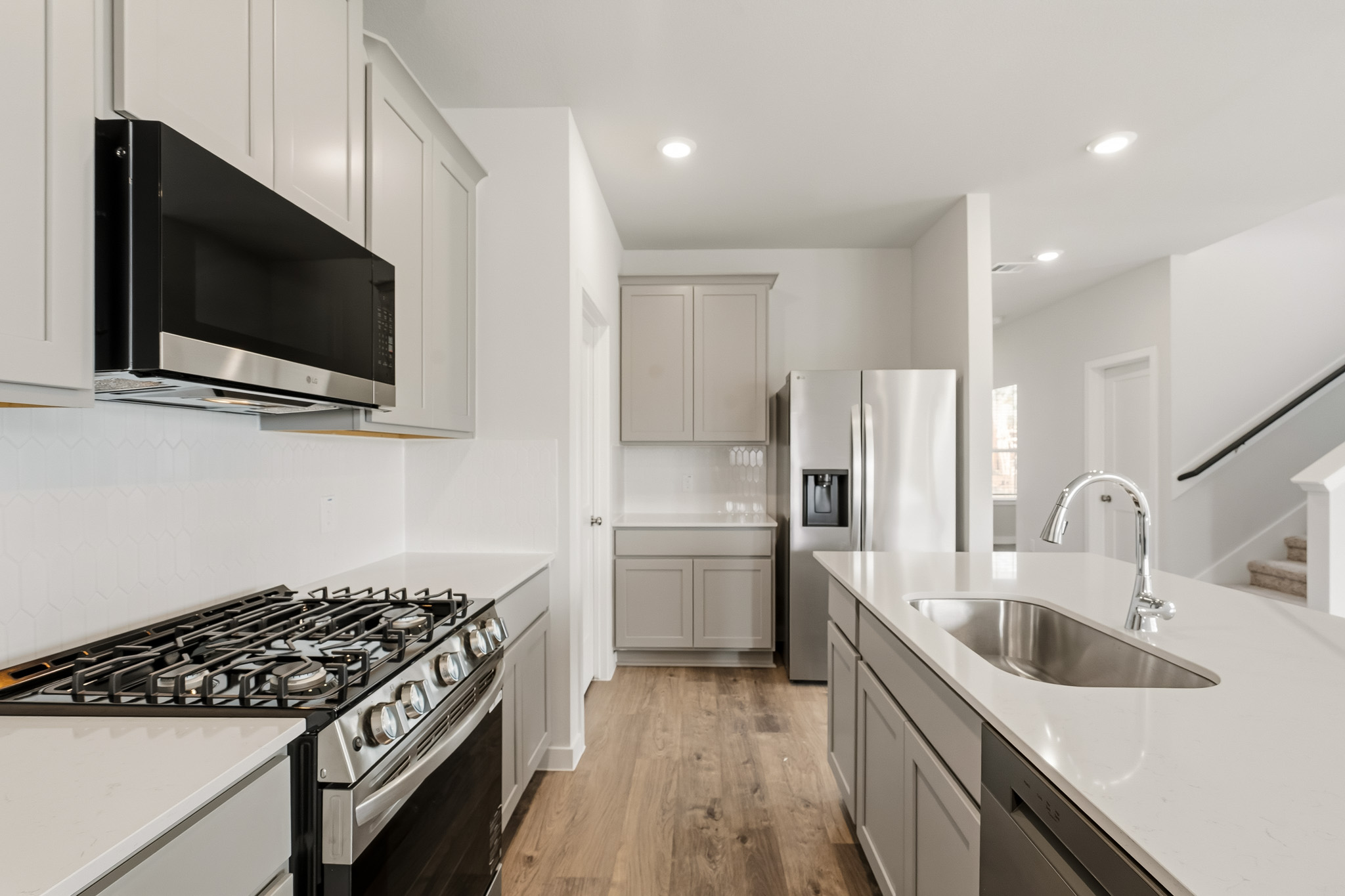 A kitchen with white cabinets.