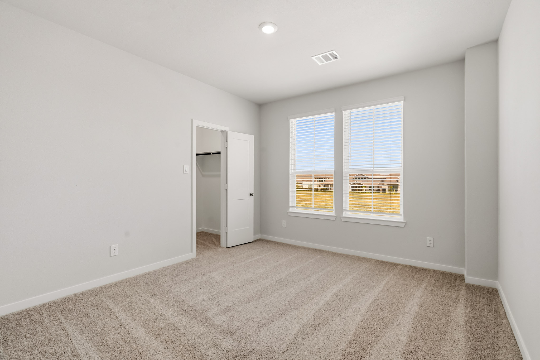 A room with a window and a door.