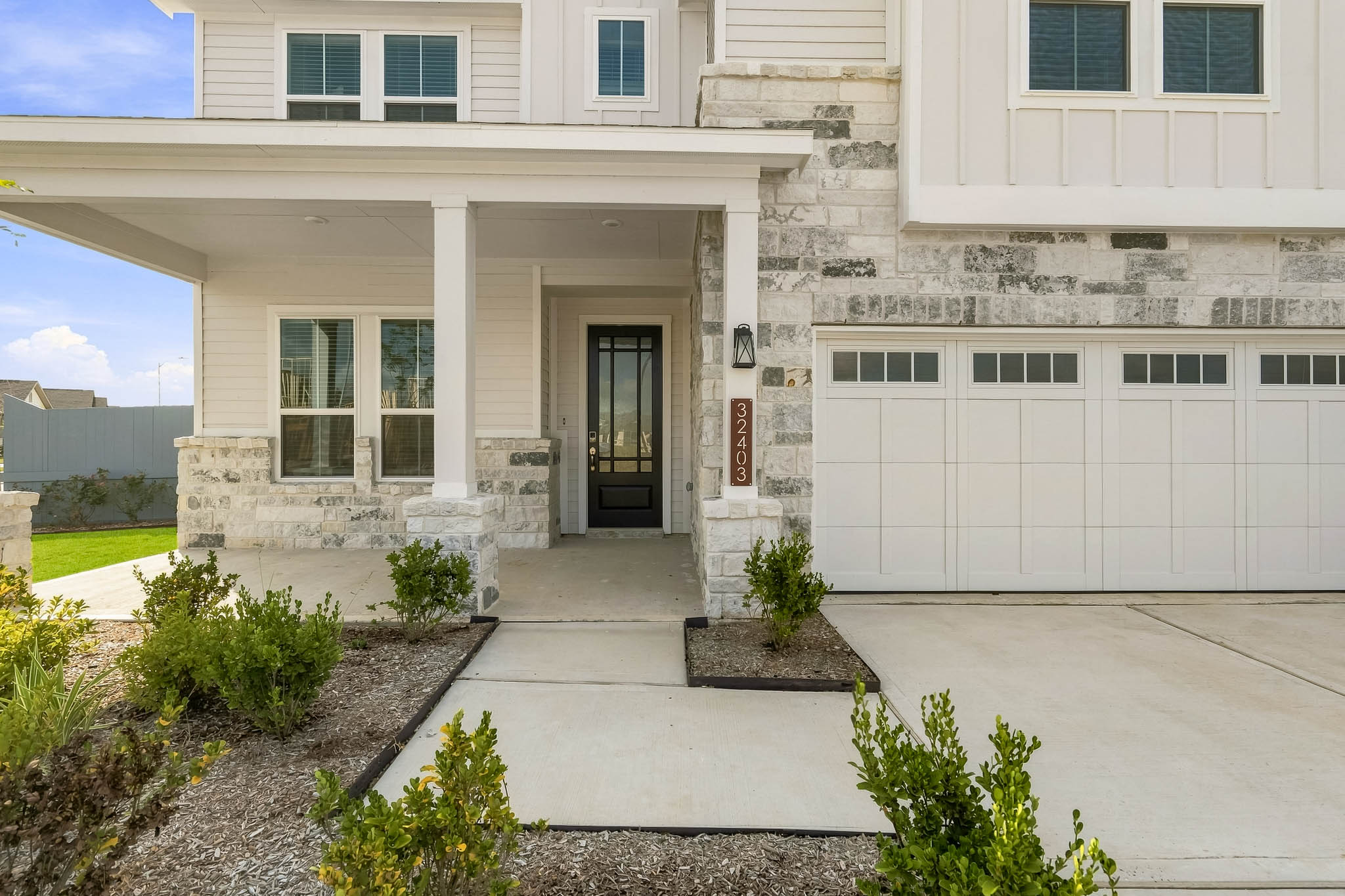 A white building with a driveway.