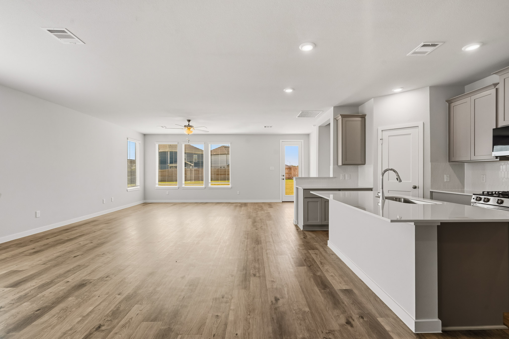 A kitchen with white cabinets.
