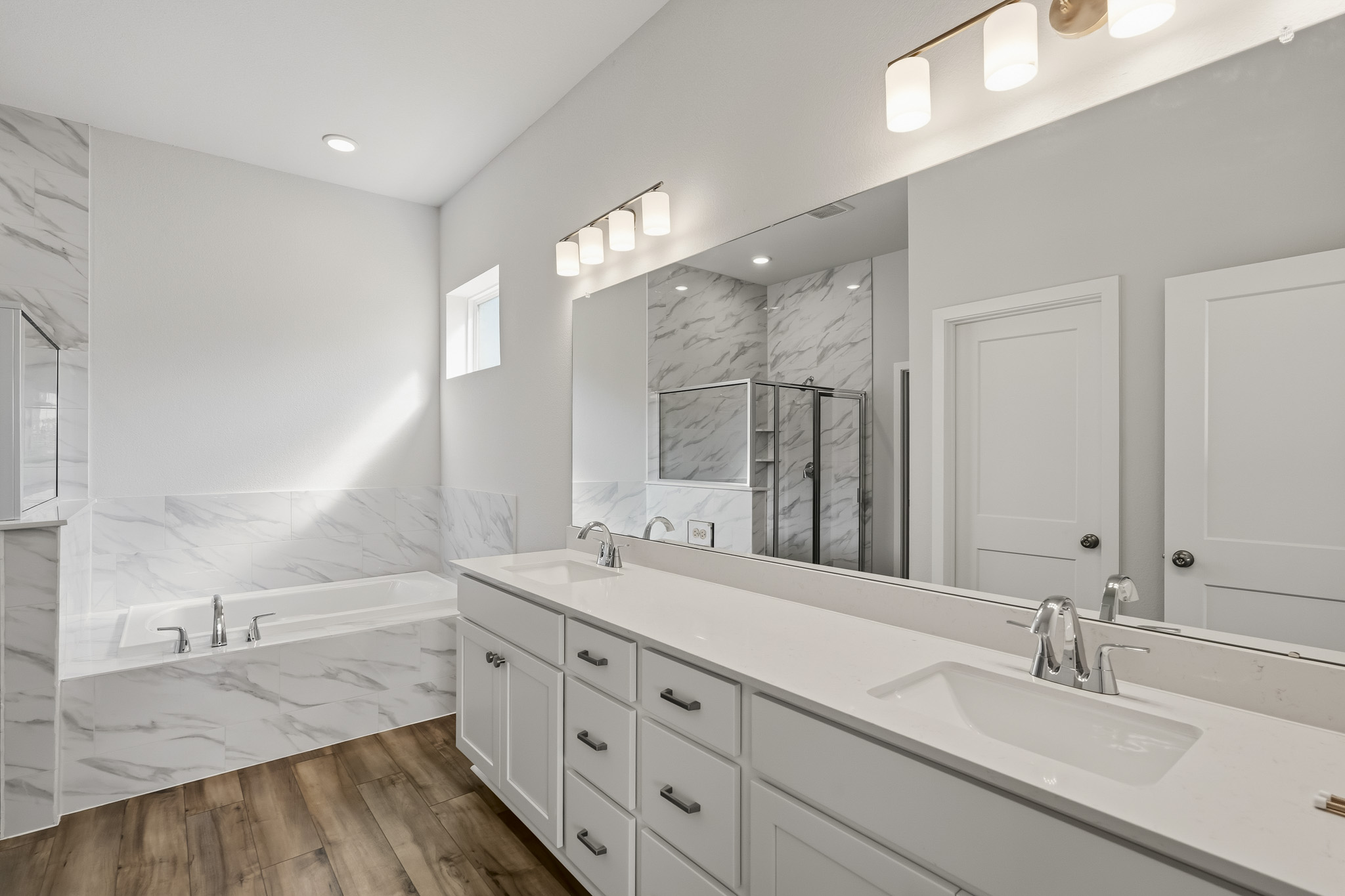 A bathroom with a large mirror.