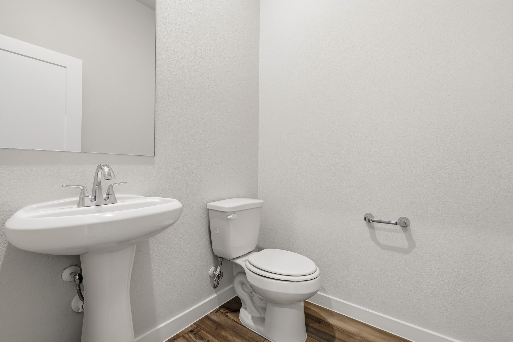 A bathroom with a toilet and sink.
