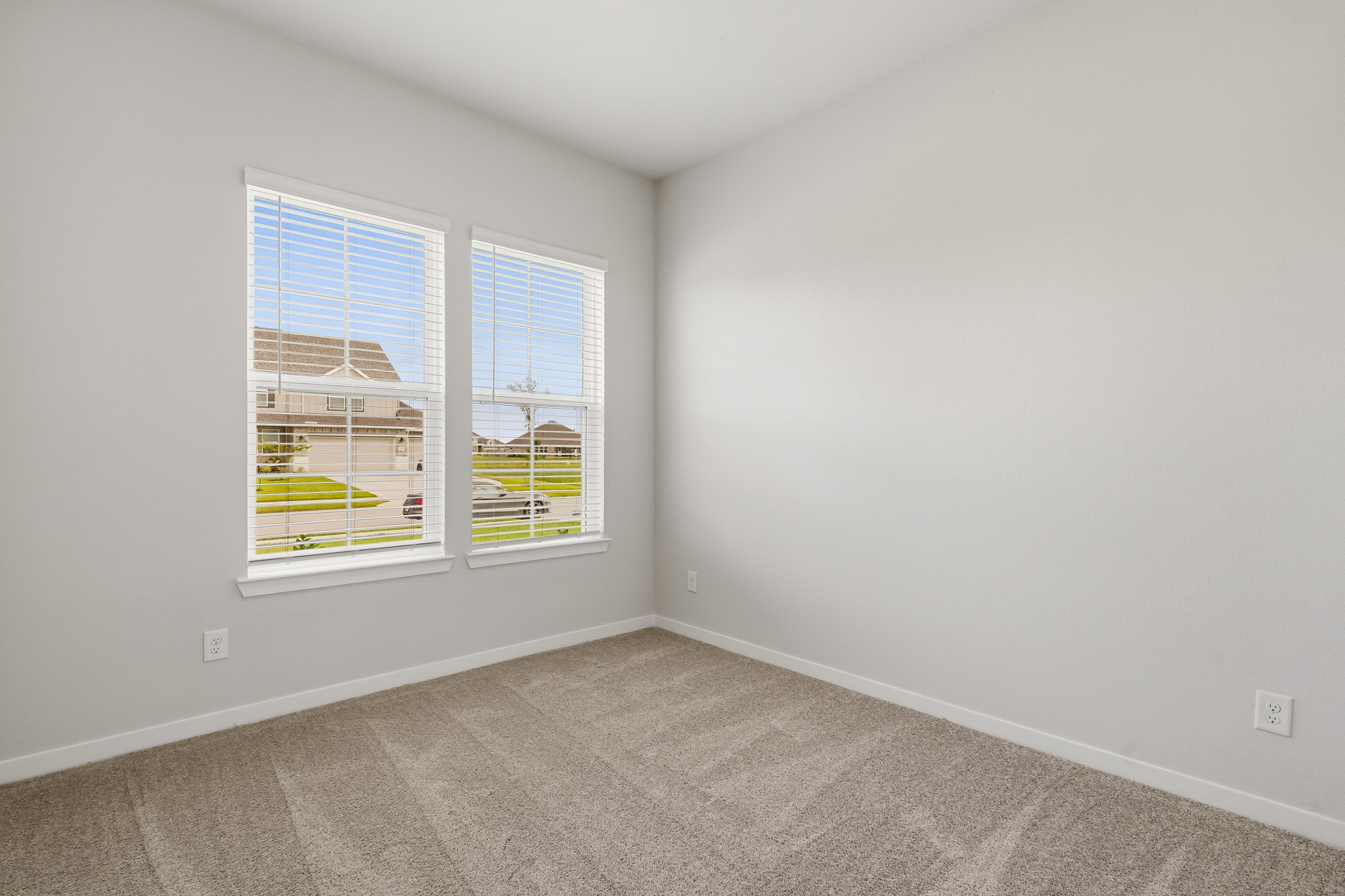 A room with a window and a carpet.