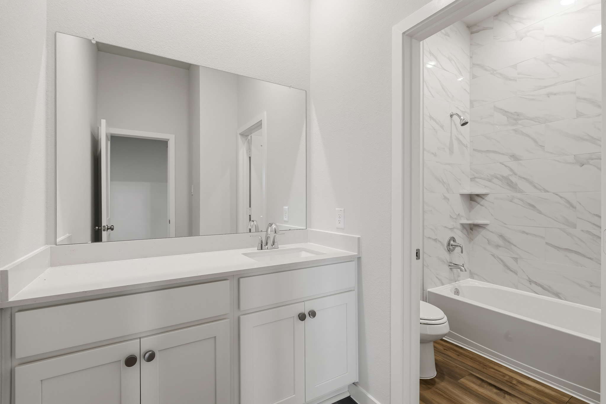 A bathroom with a tub sink and toilet.