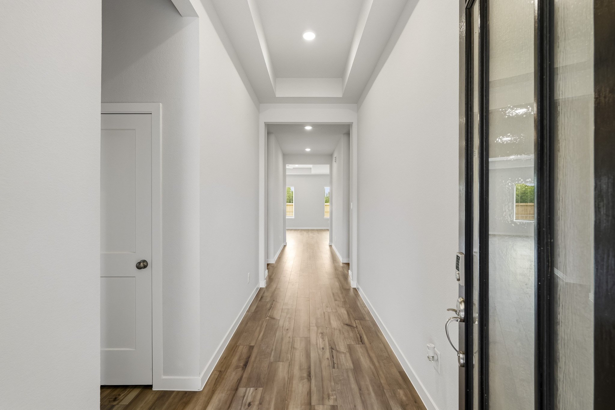 A hallway with white doors.