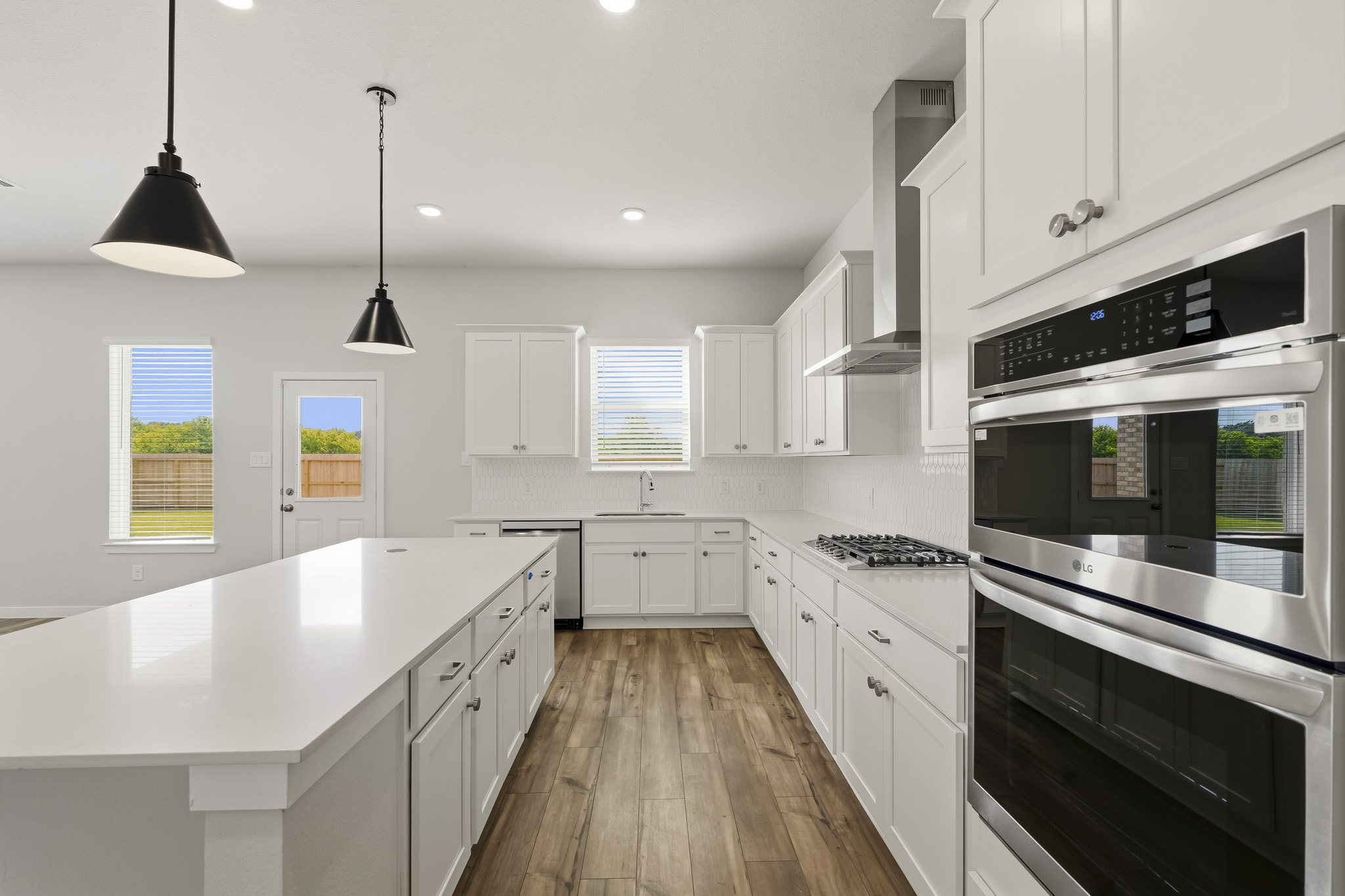 A kitchen with white cabinets.