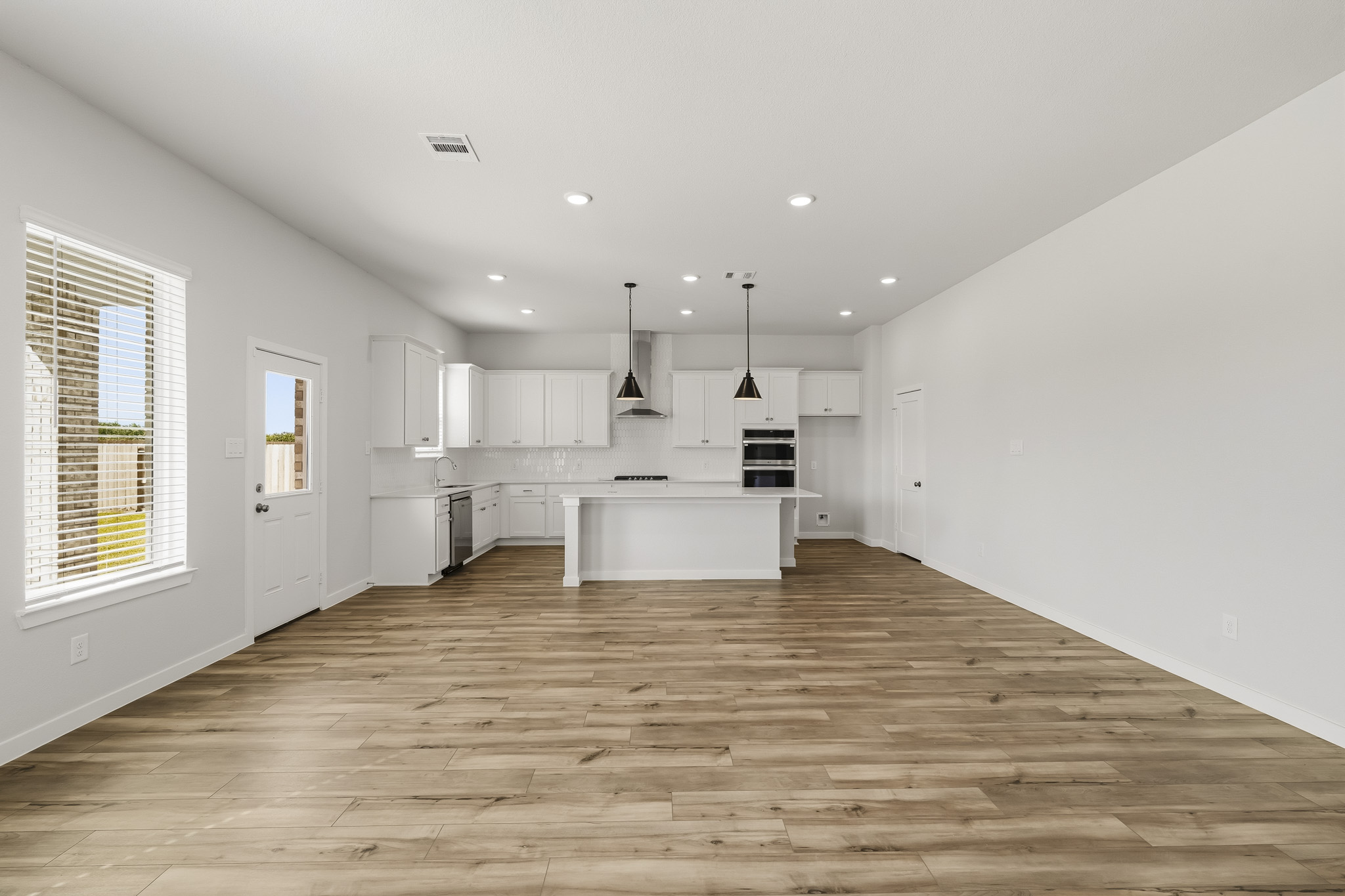 A kitchen with white cabinets.