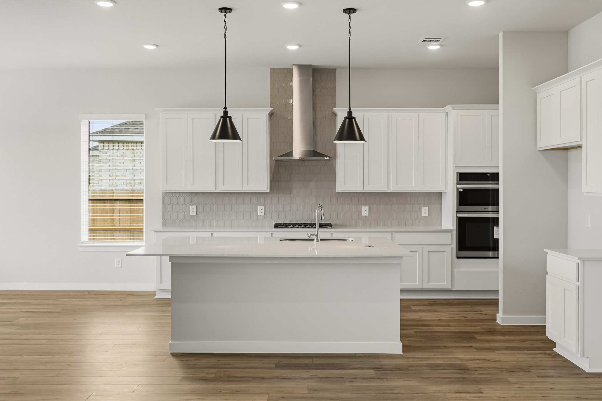 A kitchen with white cabinets.