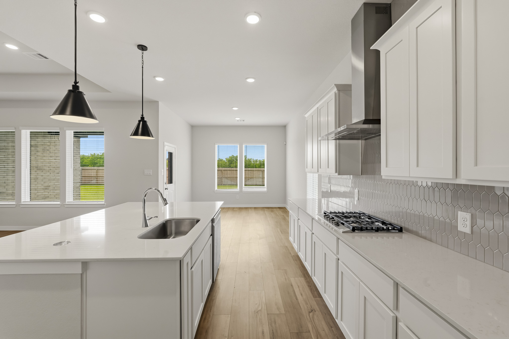 A kitchen with white cabinets.