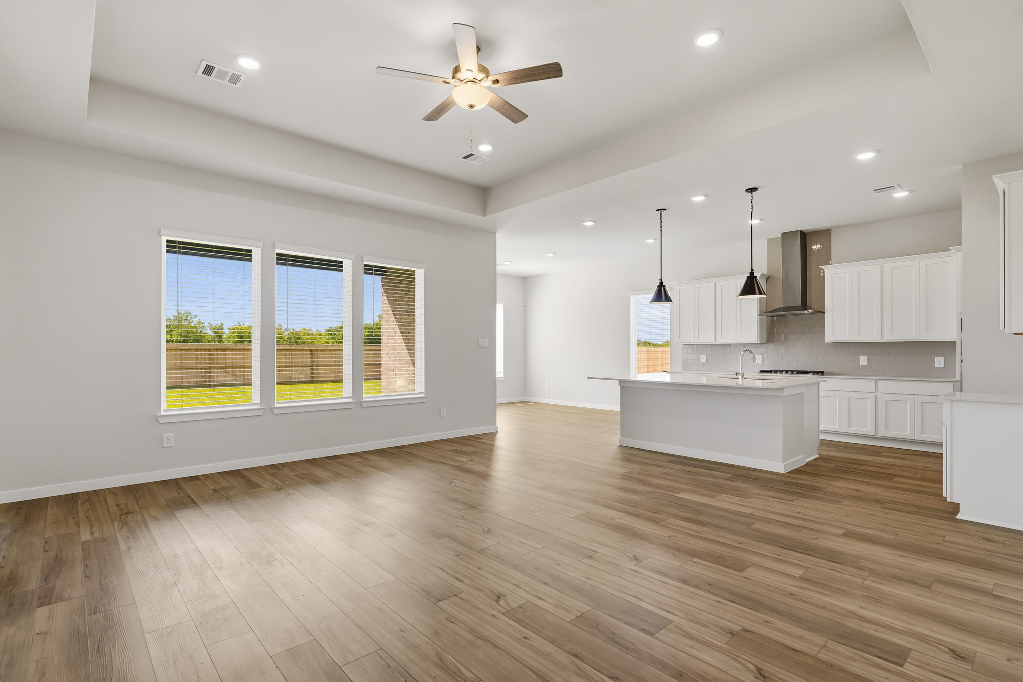 A kitchen with a wood floor.