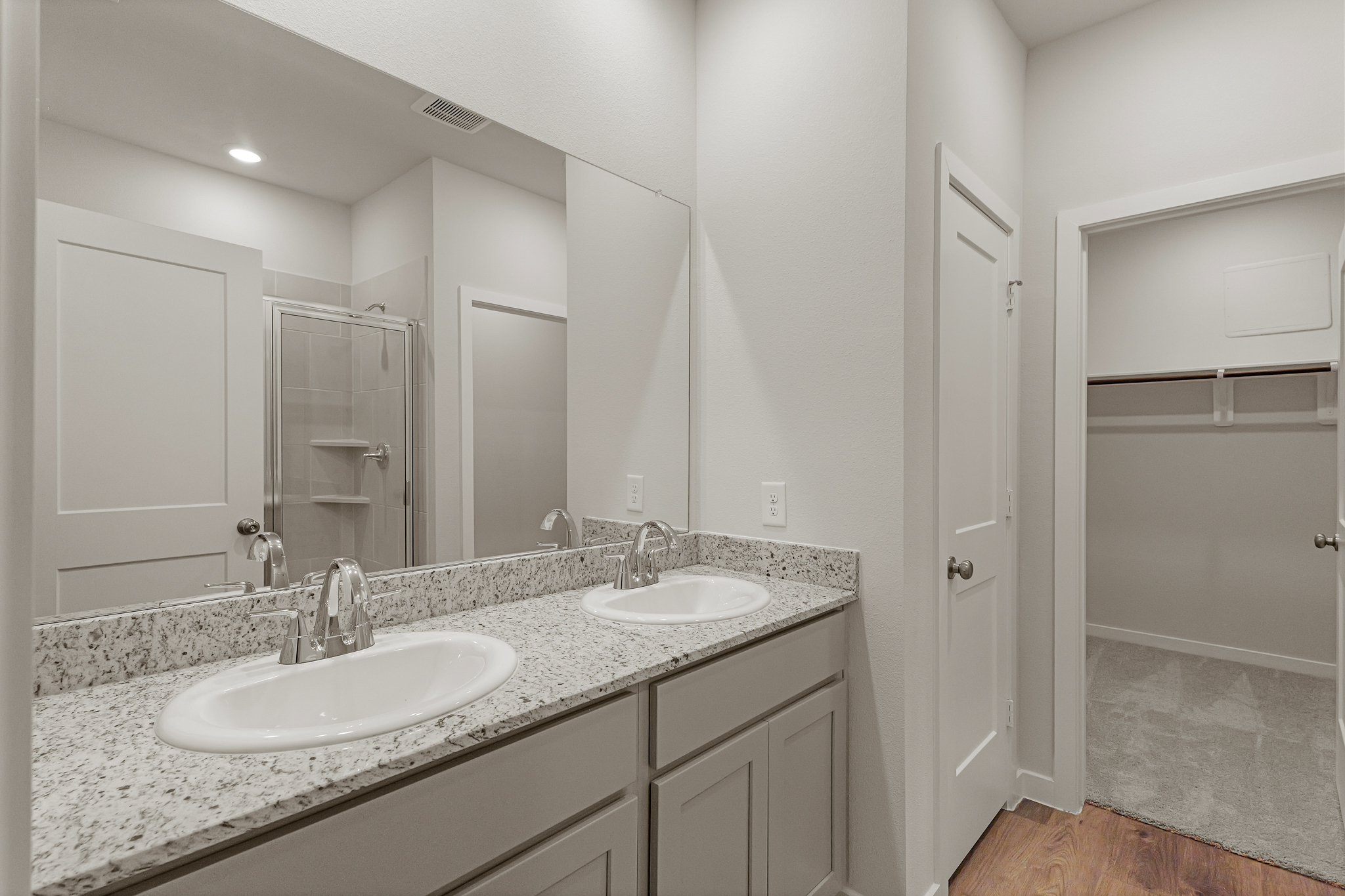 A bathroom with a large mirror.